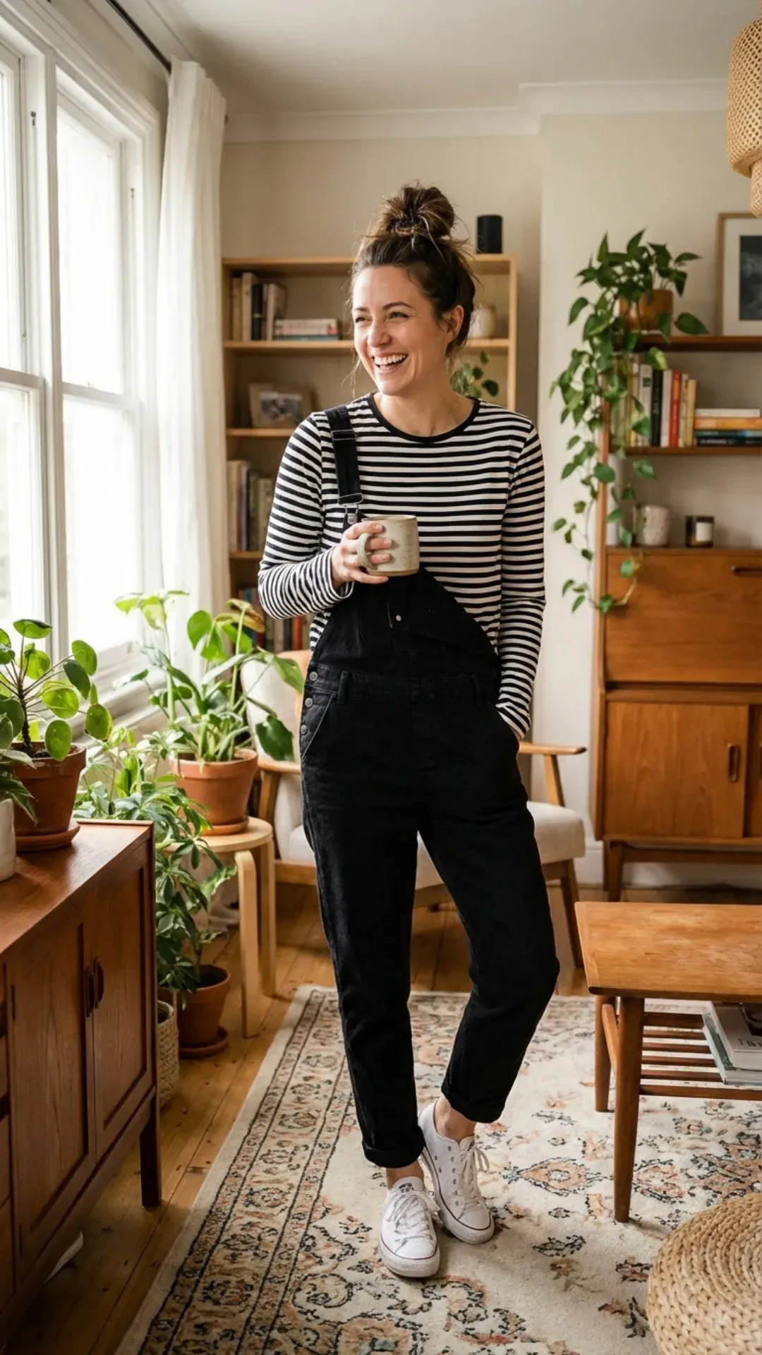 Black denim overalls and striped shirt for a cute casual outfit.