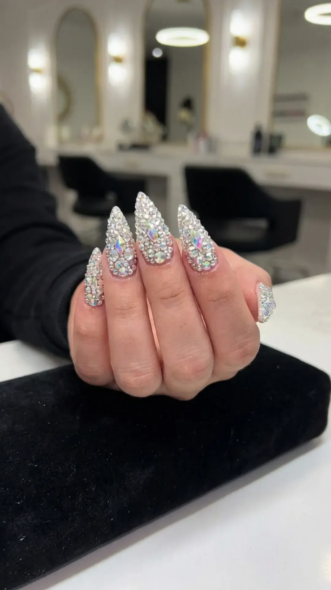 Stiletto nails completely covered in crystals for maximum glam