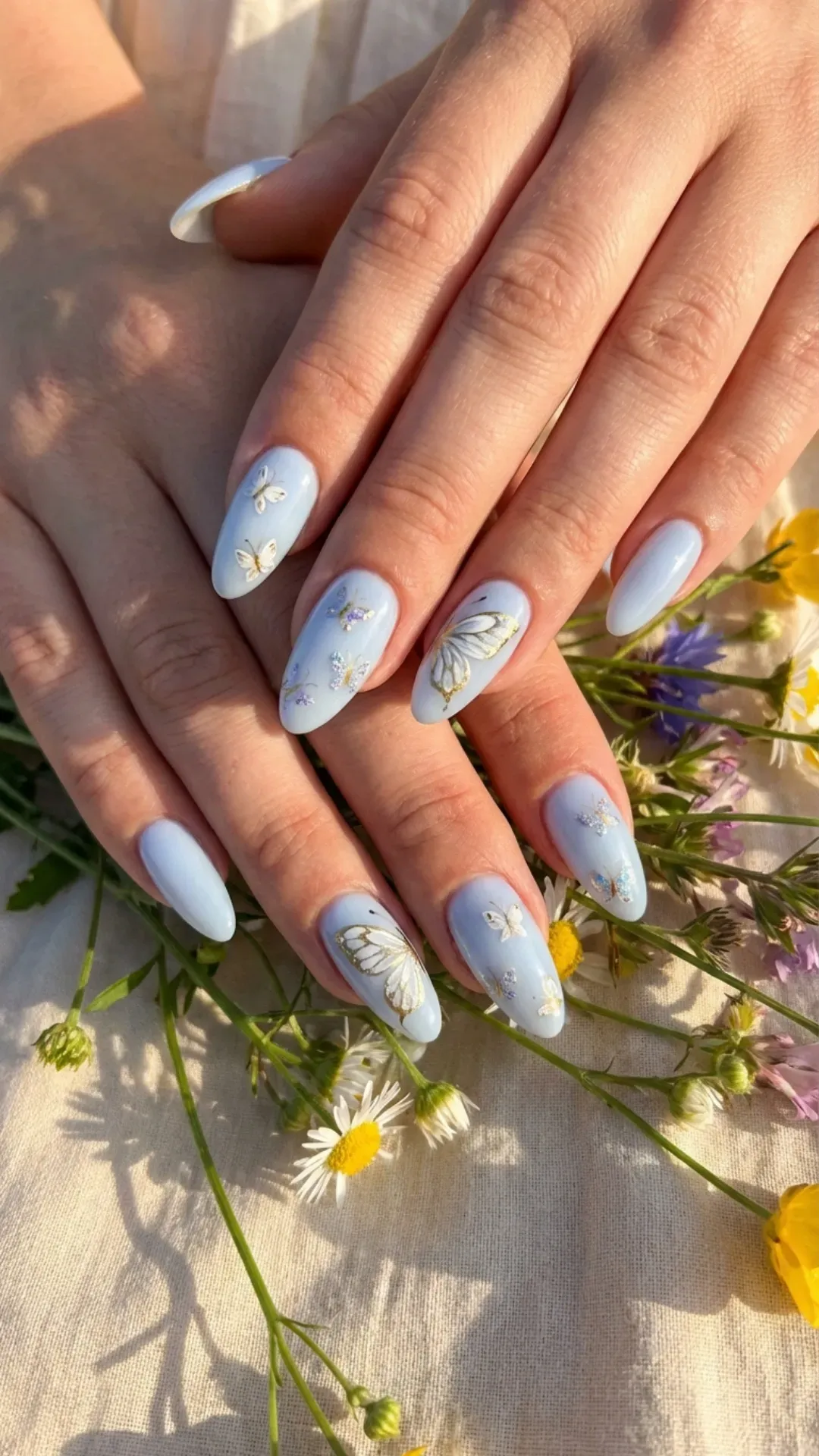 Elegant blueberry milk nails with intricate butterfly designs, symbolizing the joyful freedom of summer