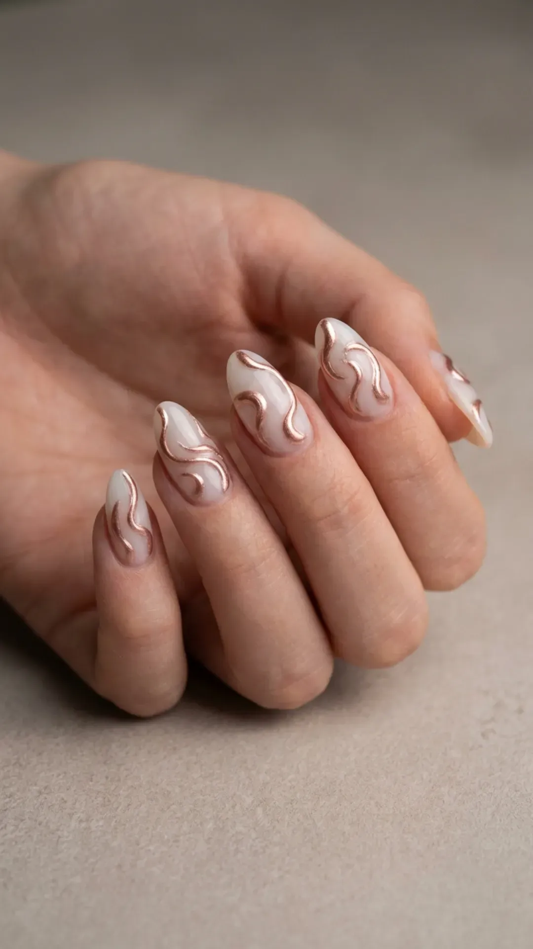 milky almond nails with 3D abstract rose gold swirls by VANSWEG.COM