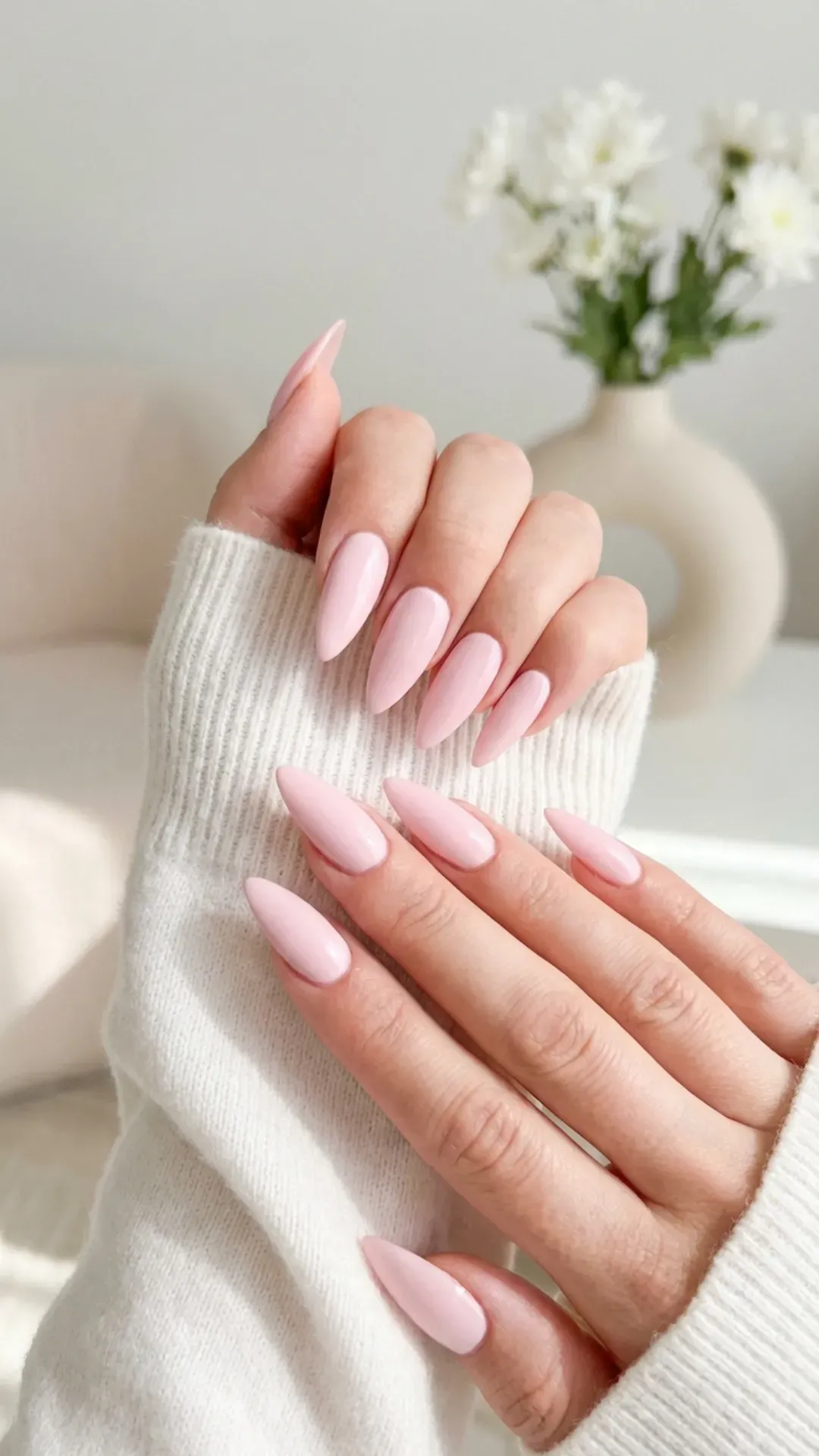 Glossy baby pink stiletto nails with long pointed tips