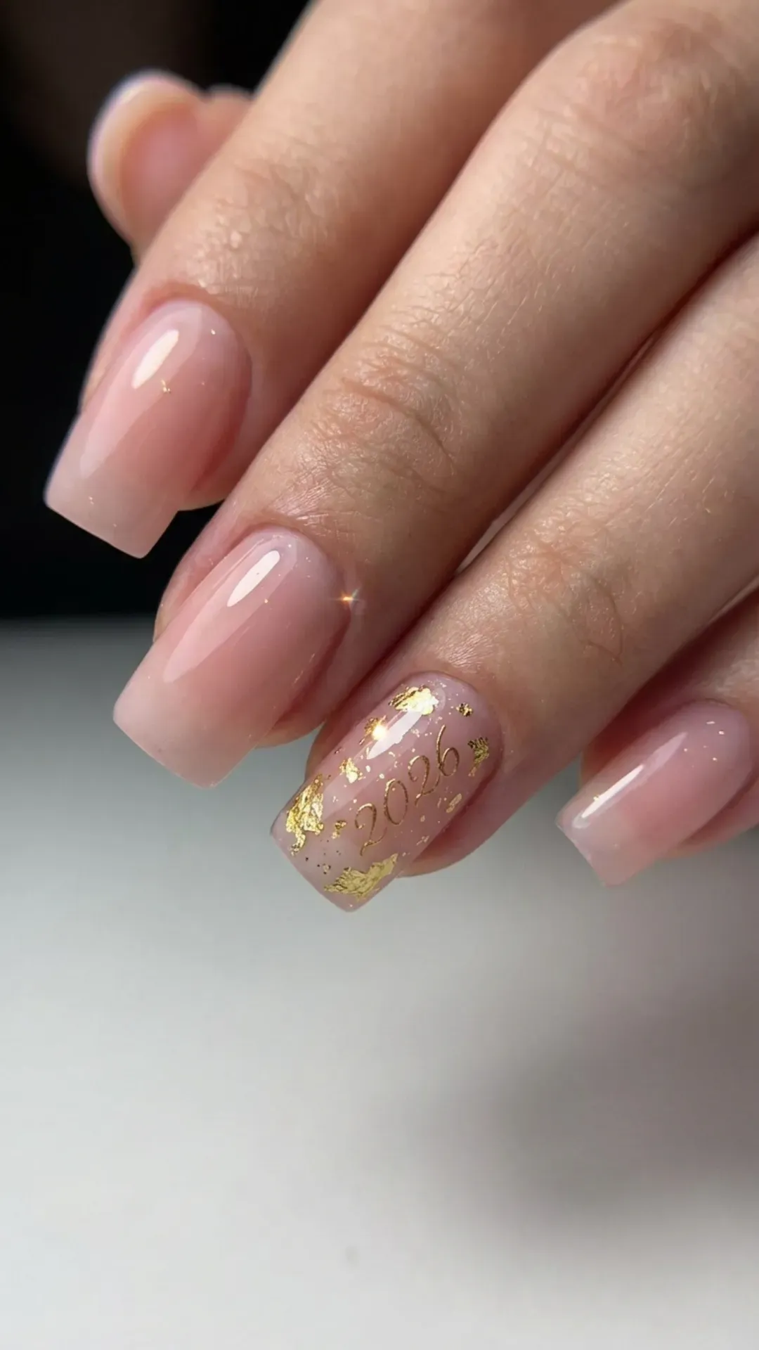 sheer pink base with 24k gold leaf and 2026 calligraphy graduation nails by VANSWEG.COM