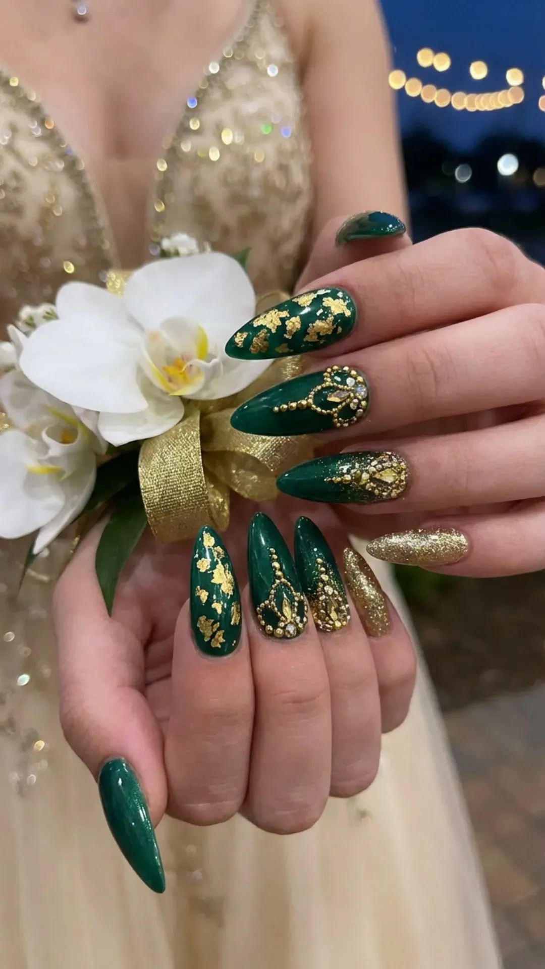 Deep green prom nails with gold accents and elegant almond shape