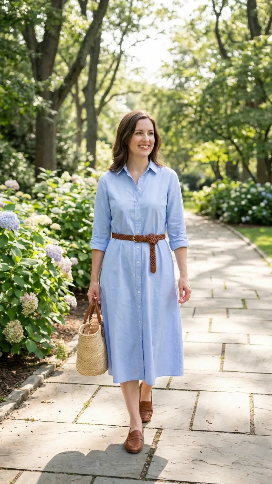 Light blue poplin shirt dress styled with a woven belt for a classic outfit.