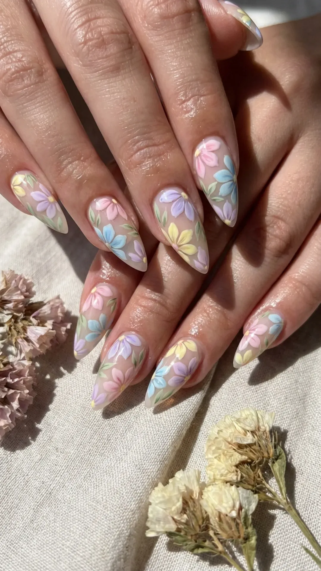 Stiletto nails featuring delicate hand-painted floral designs