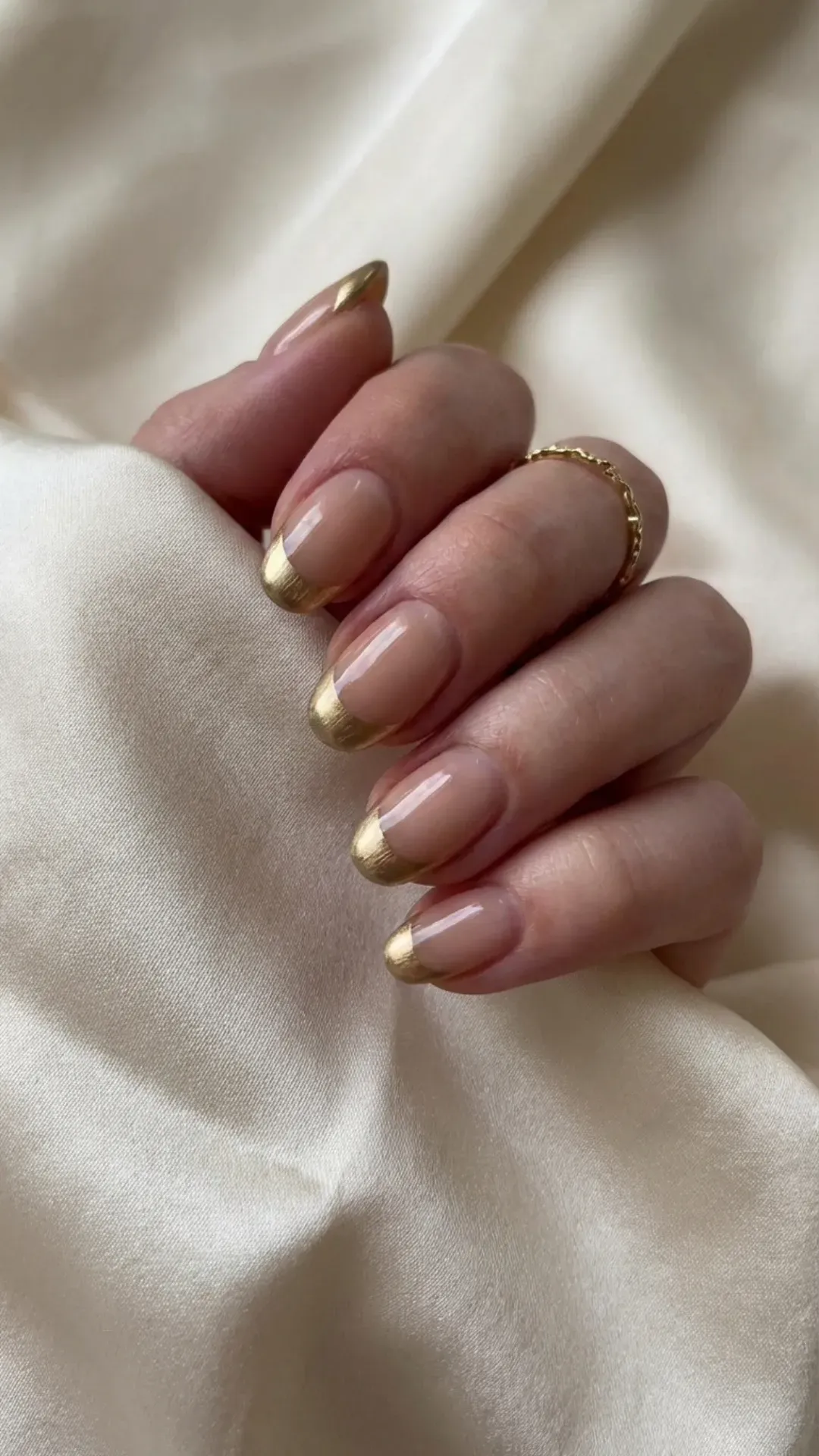Sheer nude prom nails with metallic gold French tips, luxury manicure
