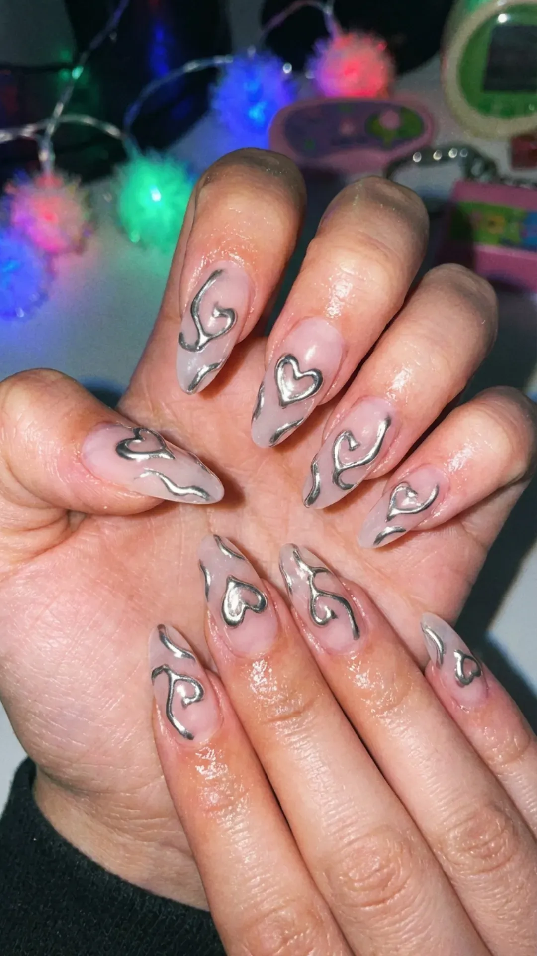 sheer pink almond nails with 3D liquid silver chrome hearts by VANSWEG.COM