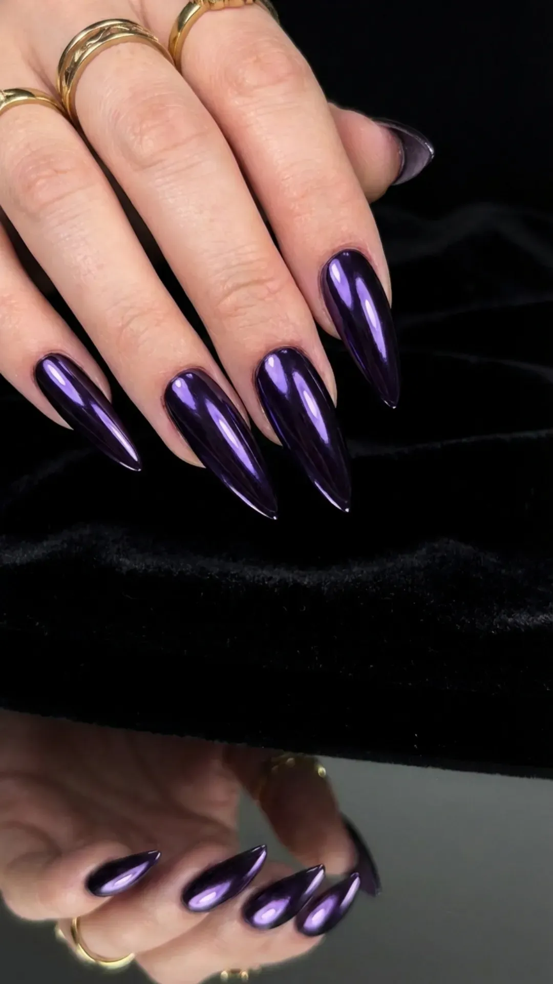 Long stiletto nails with bold reflective purple chrome finish