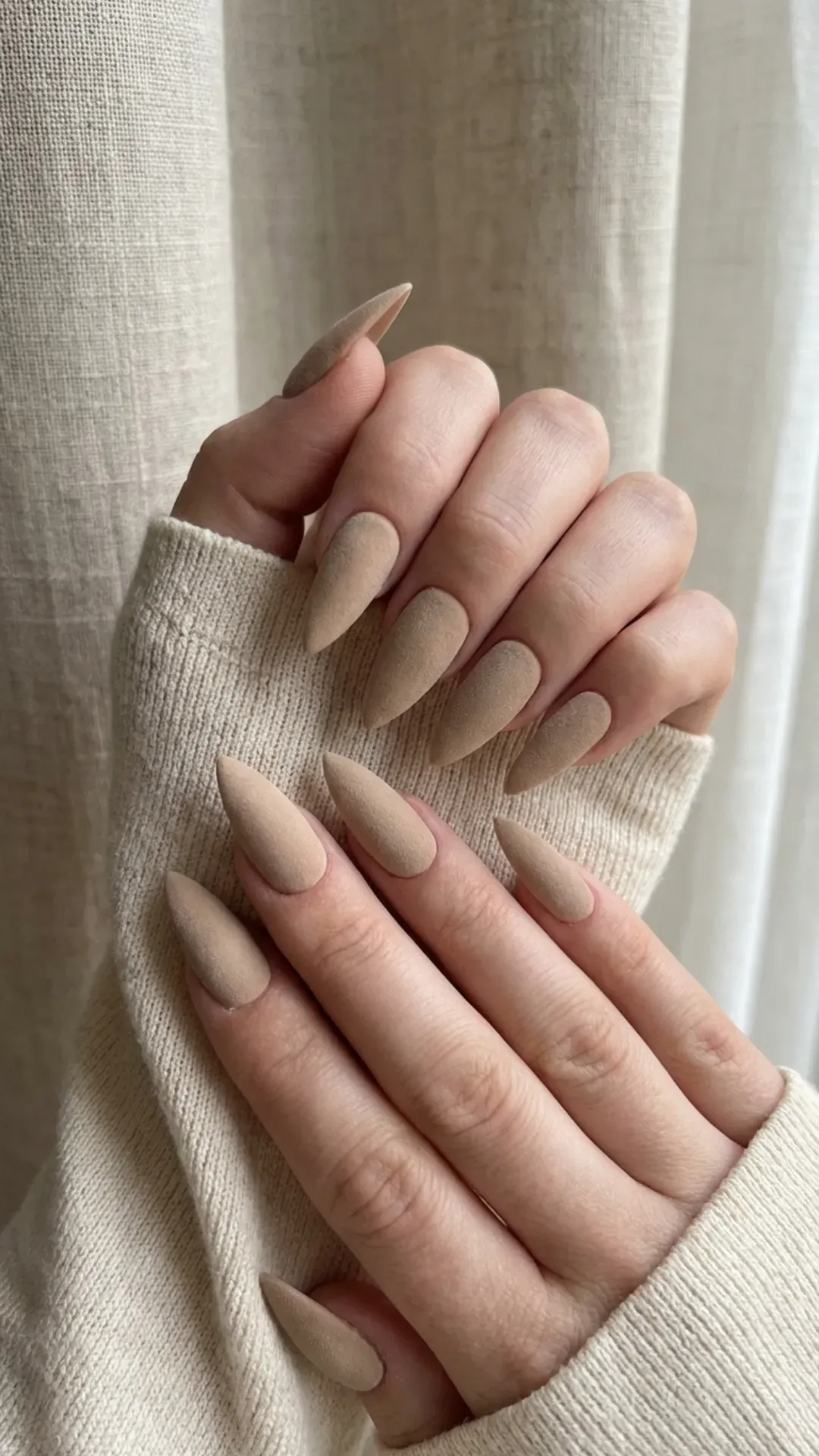 Matte beige stiletto nails with a velvety finish and long pointed tips