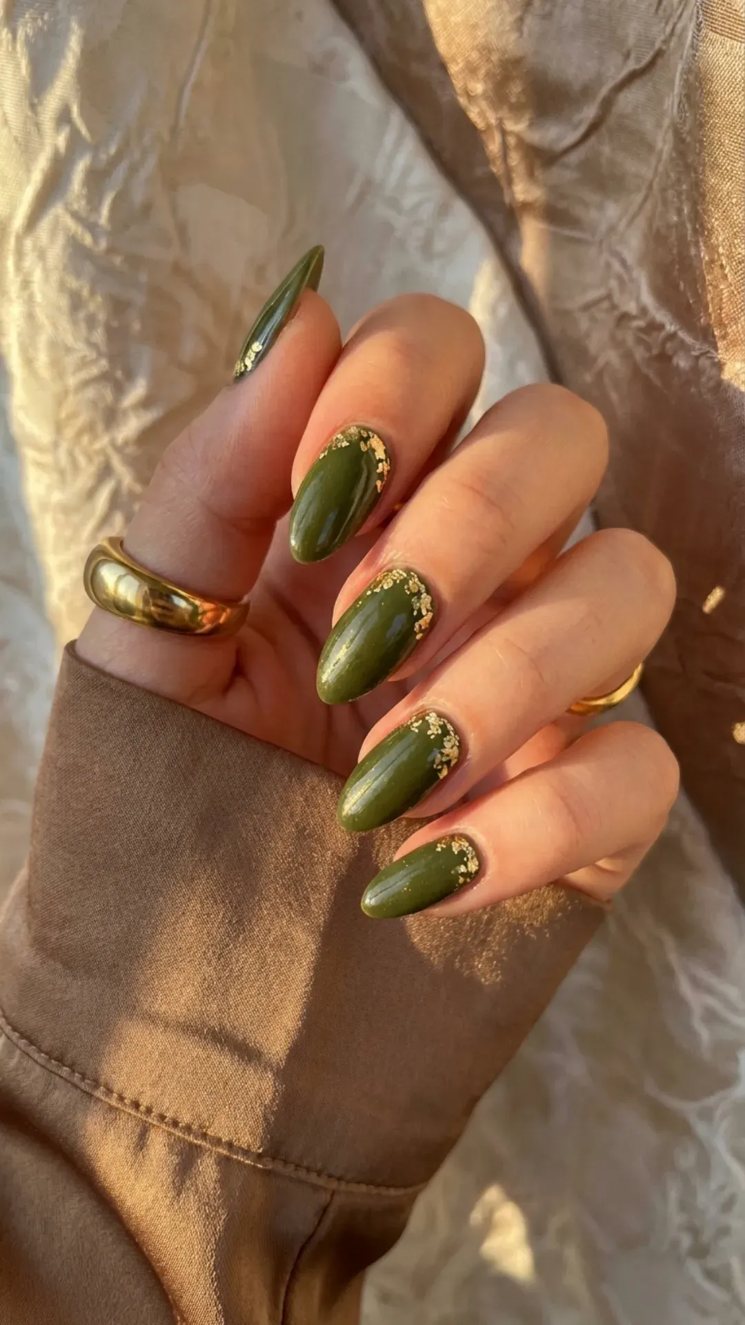 Glossy olive green nails encapsulated with delicate gold leaf flakes VANSWEG.COM