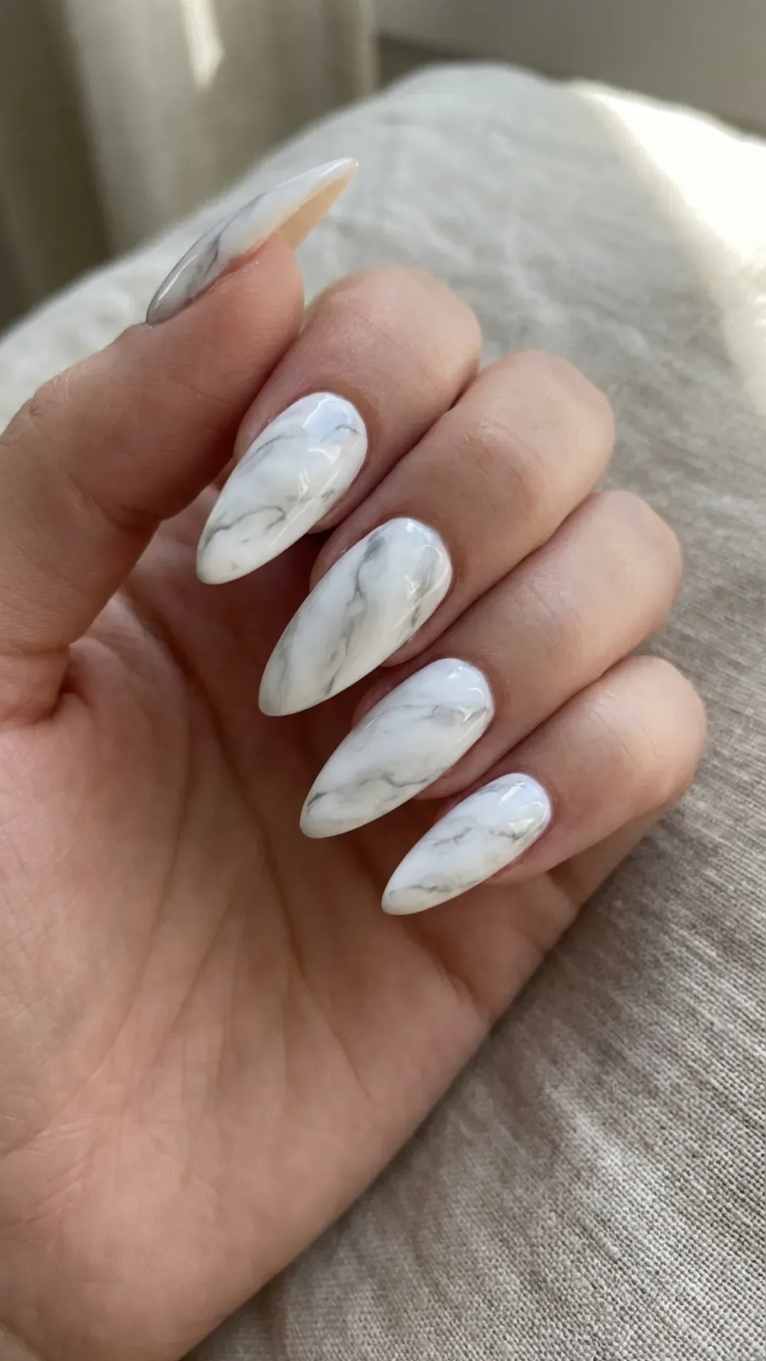 White marble stiletto nails with elegant gray veining