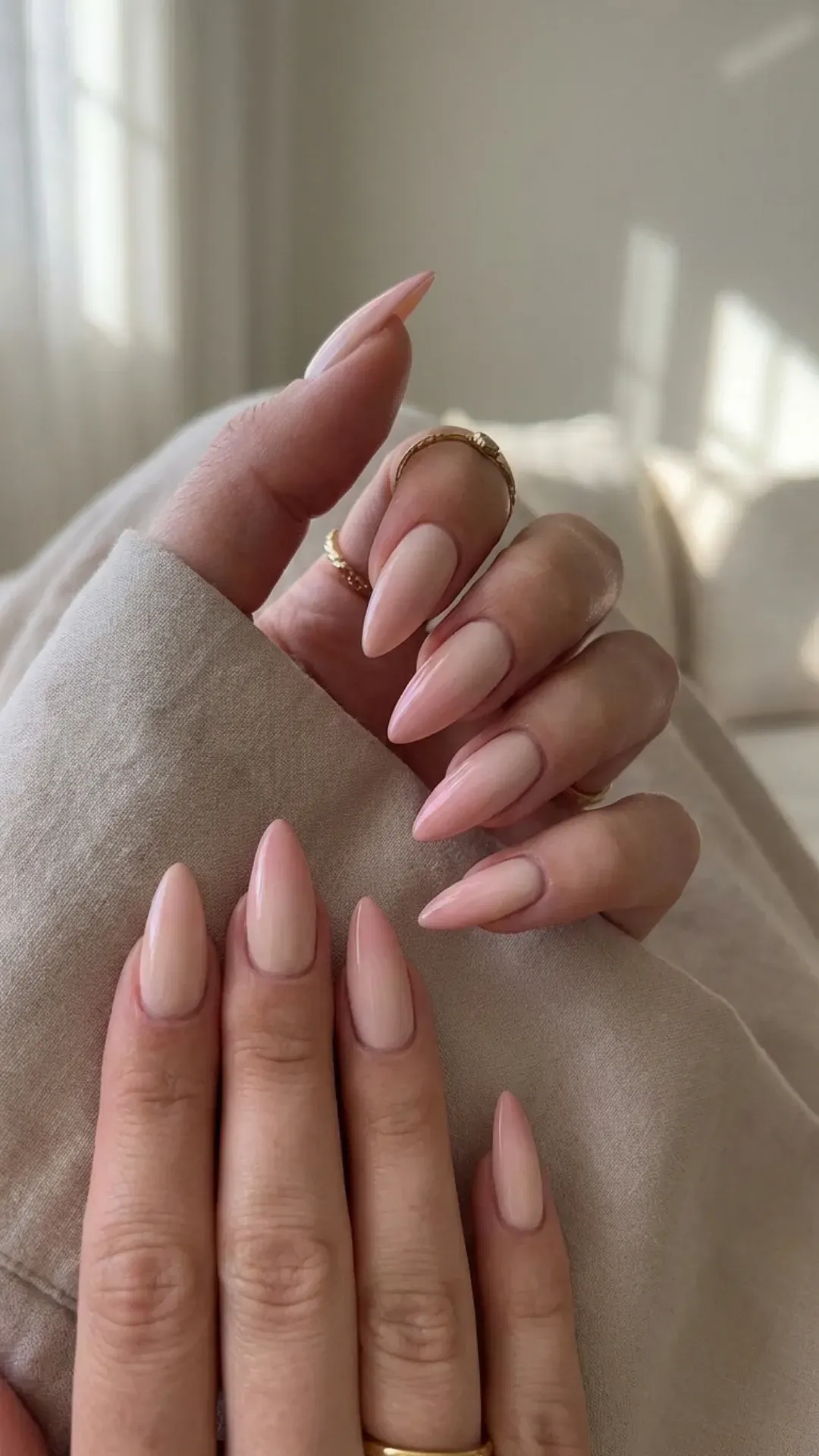 Nude ombre stiletto nails blending beige into blush pink