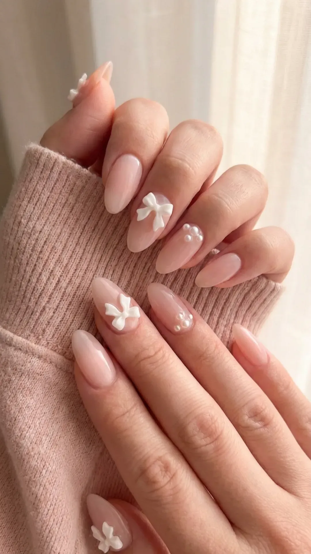 blush pink almond nails with 3D bows and micro-pearls by VANSWEG.COM