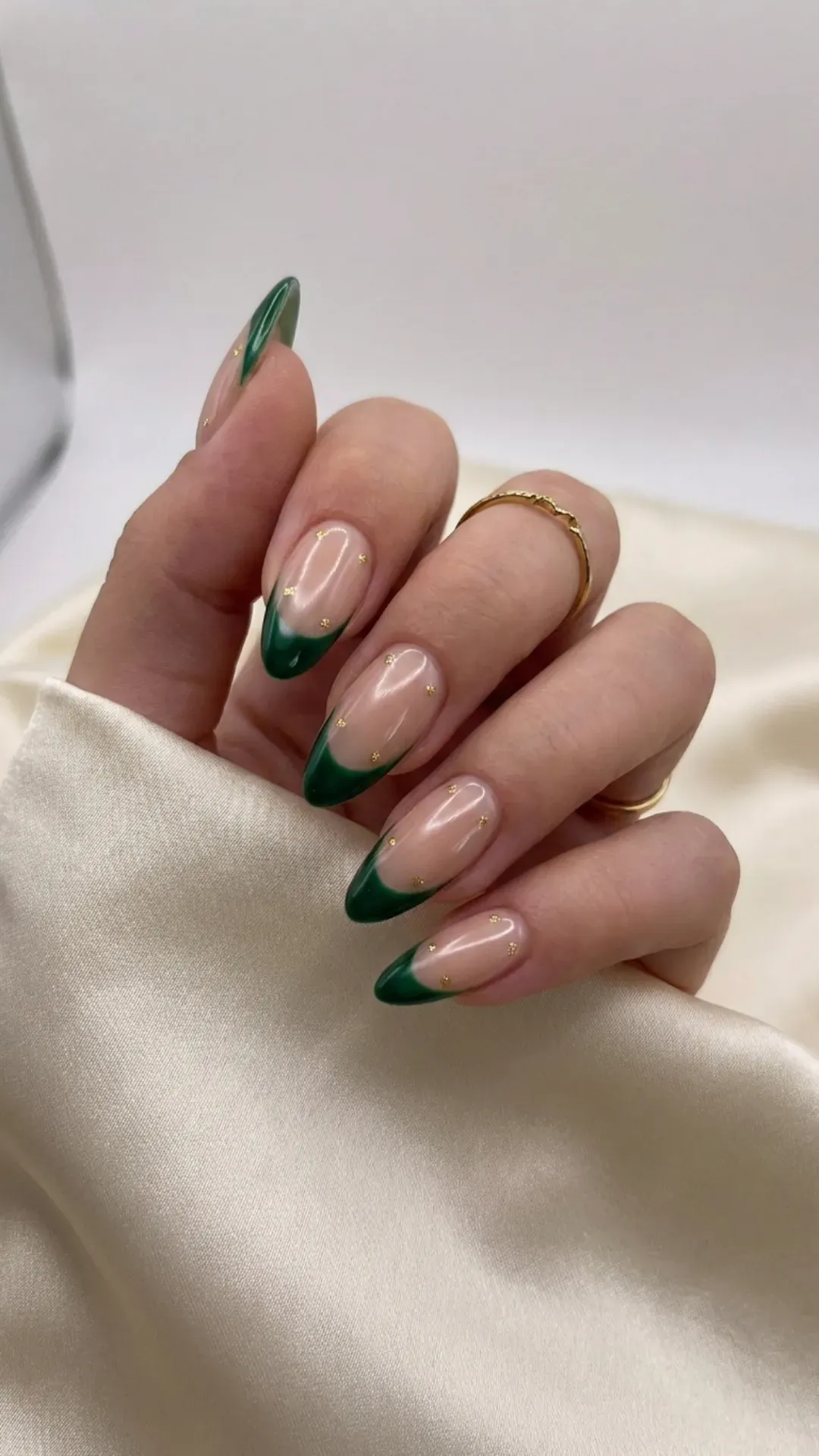 Minimal green French tip nails on nude base with gold accents