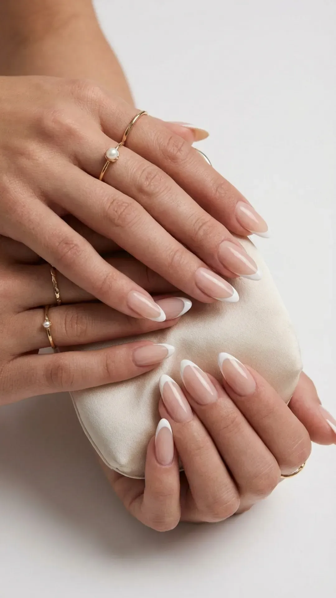 Sheer nude almond nails with modern micro French tips, classy prom manicure