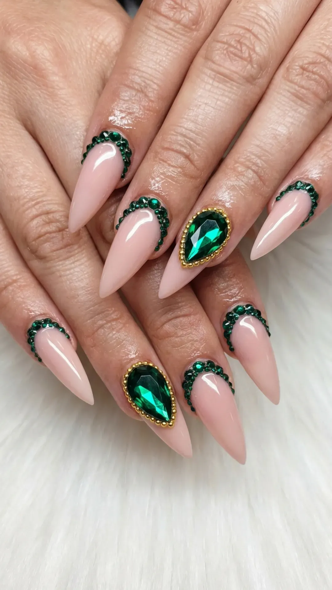 Dark emerald green stiletto nails with crystal details and glossy finish