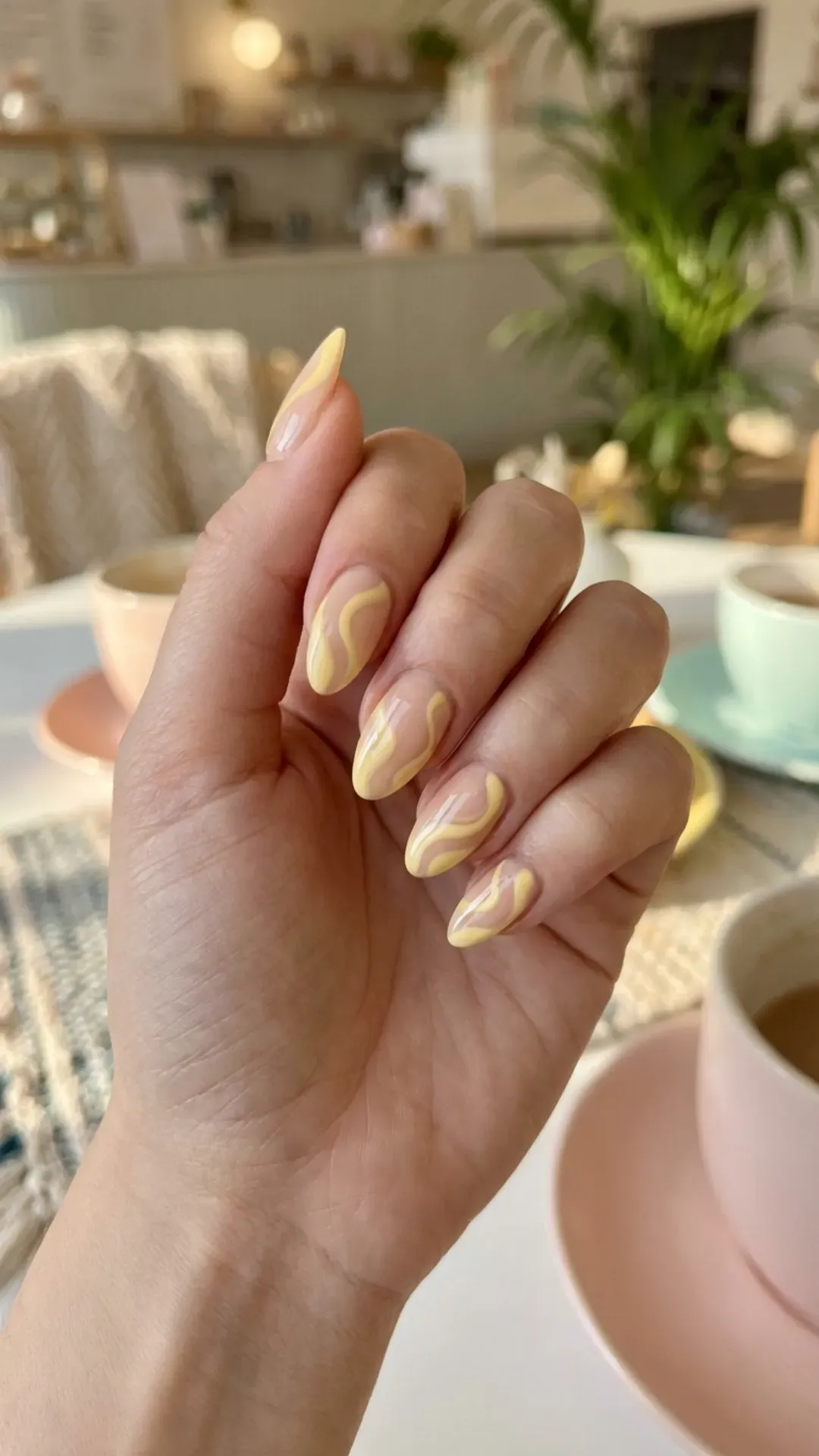 Retro butter yellow swirl nail art over nude base VANSWEG.COM