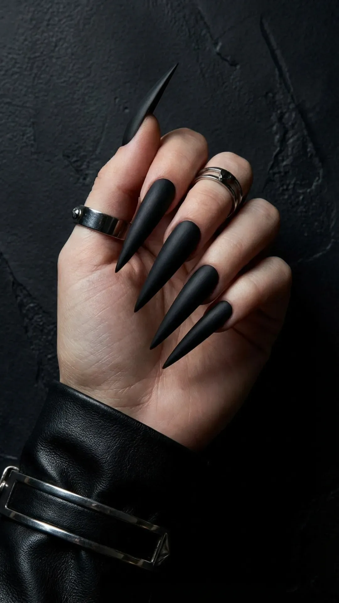 Matte black stiletto nails with sharp pointed tips
