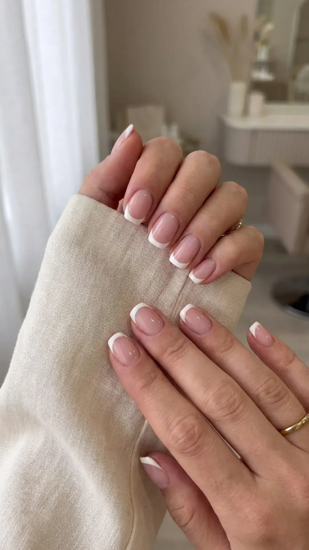 Timeless French manicure featuring a sheer pink base with classic white tips for a neat and sophisticated look