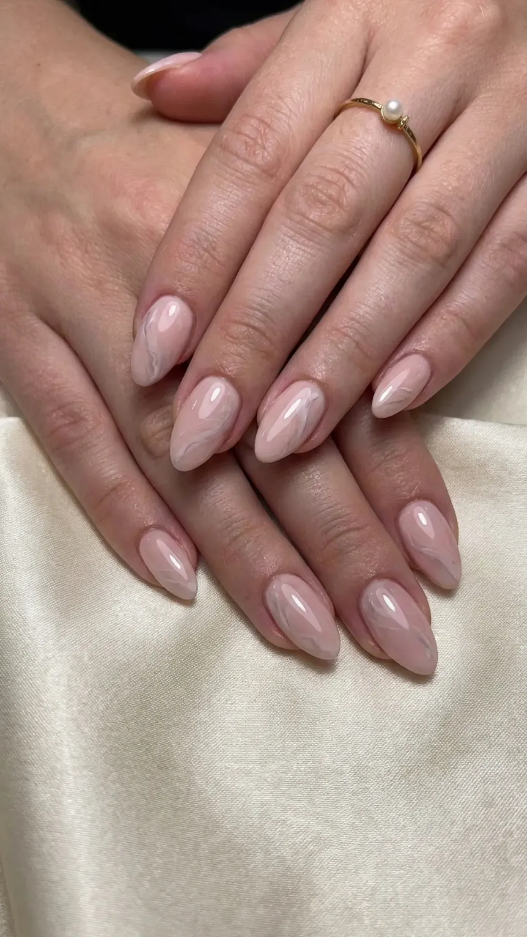 Elegant soft blush nails with a subtle marble effect, perfect for a delicate and sophisticated manicure.