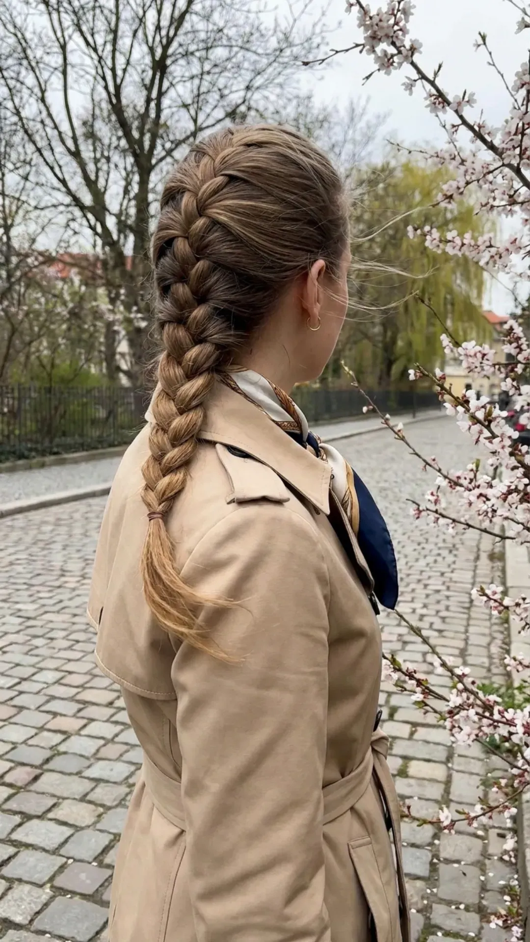 Classic and elegant French braid hairstyle providing a practical solution for managing hair during the windy days of spring, adding sophistication to the look.