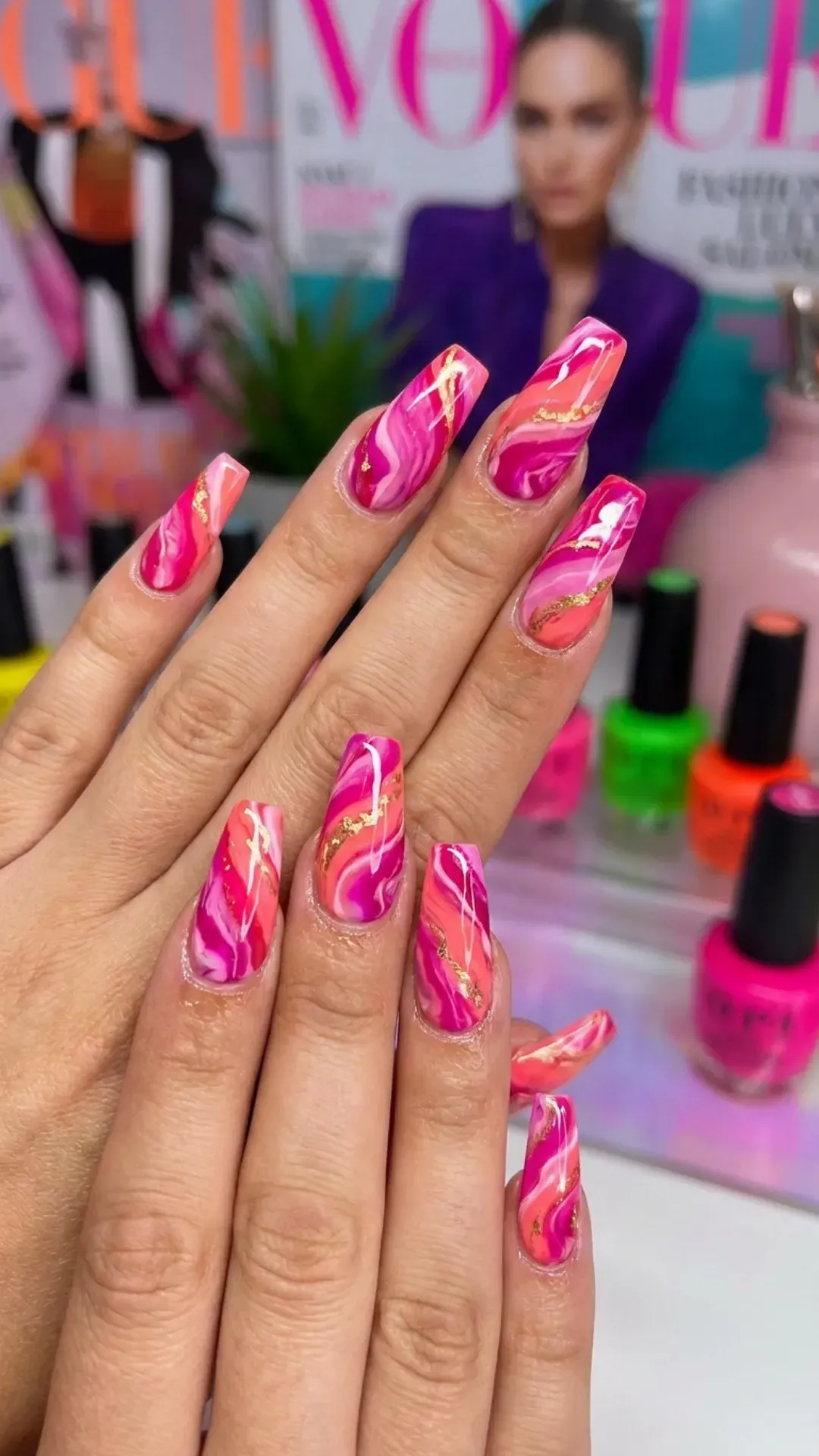 Hot pink marble nails with a fluid design, capturing a bold and energetic nail art trend.