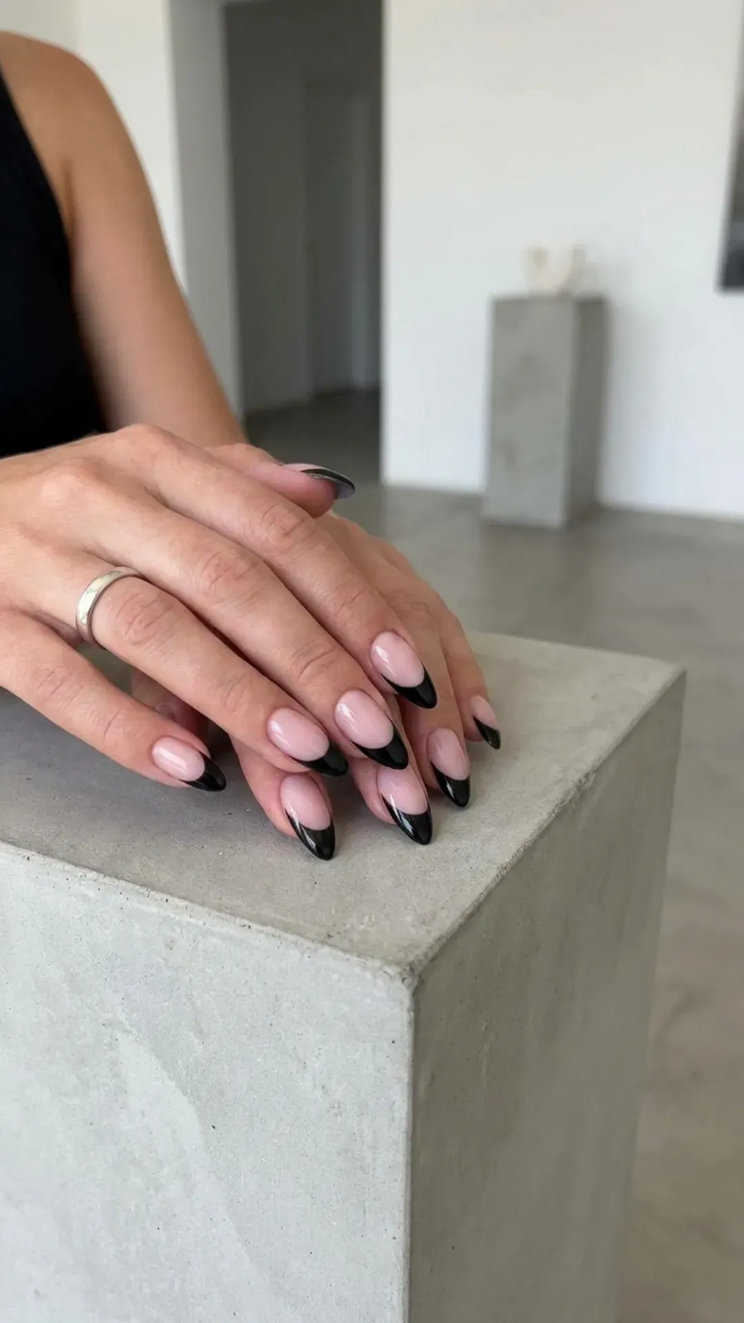 Dramatic French manicure with a sheer base, a bold crimson crescent, and a thin gold line for an added touch of elegance
