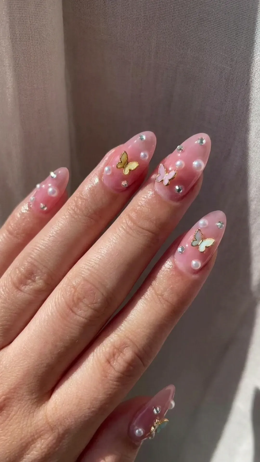 Embellished Pink Syrup Nails - Glossy pink syrup nails with 3D pearls, crystals, and butterflies