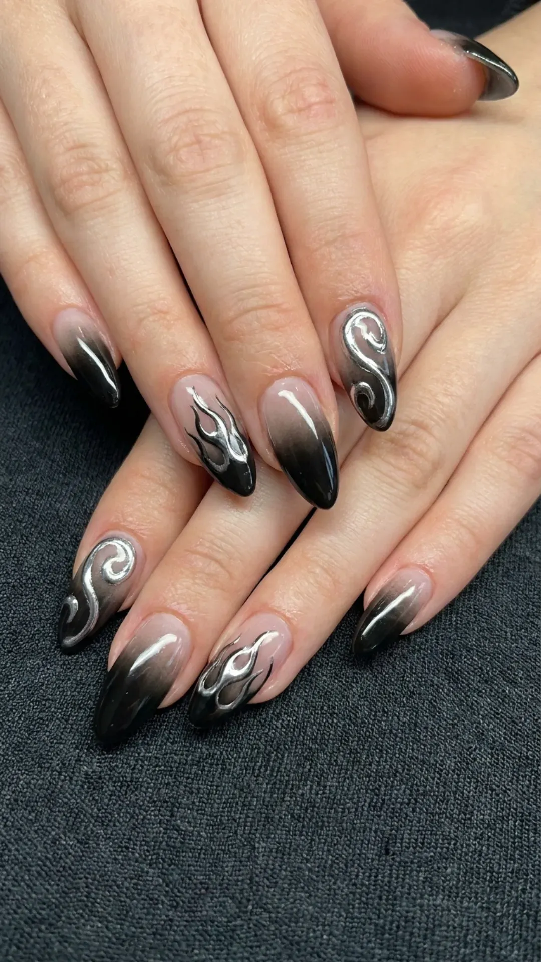 Black Ombre Nails with Silver Chrome Swirls - Almond-shaped nails with black ombre and silver flame art