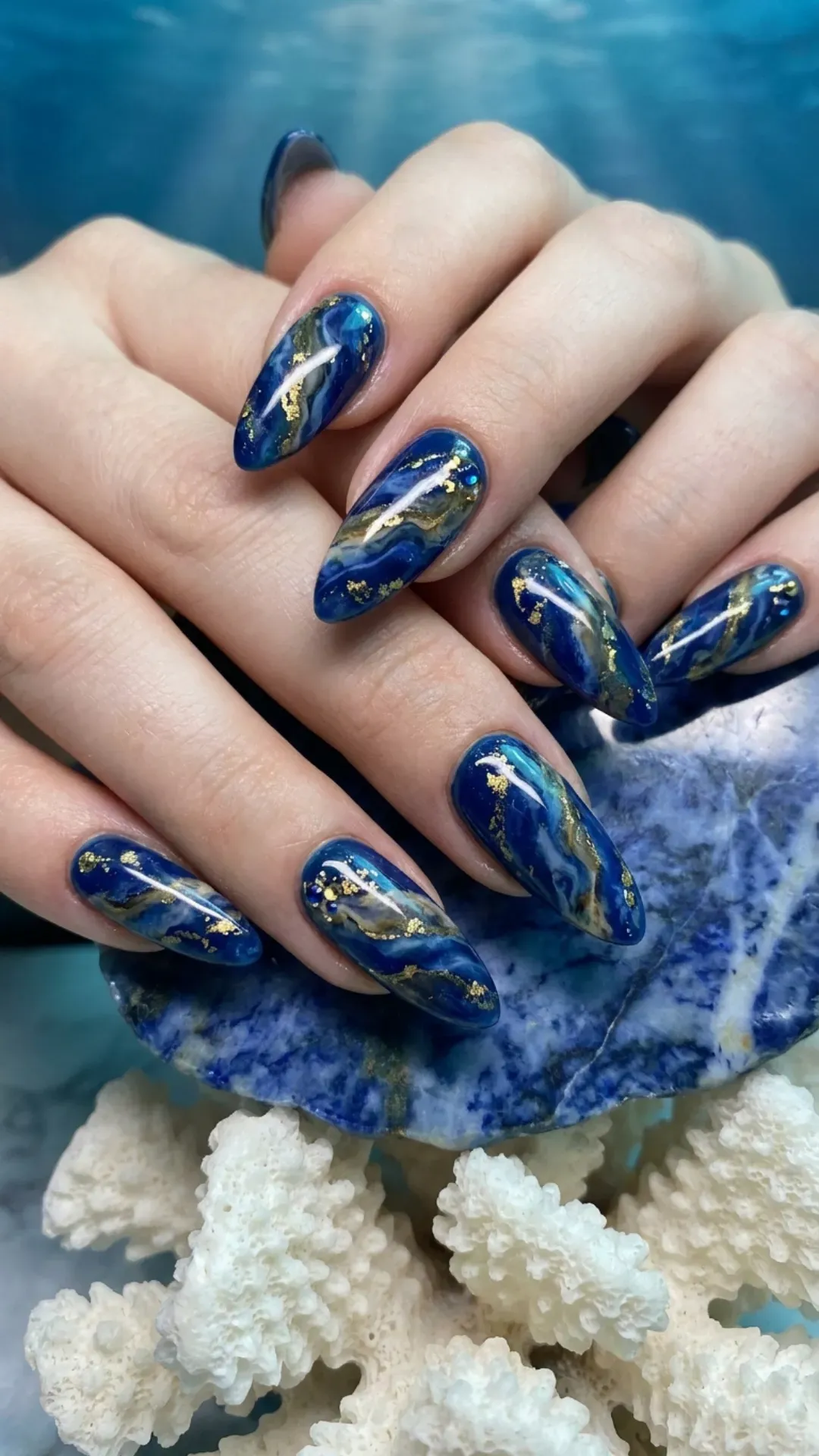 Rich deep sea blue nails with a unique marble effect, ideal for making a statement with your nail art.