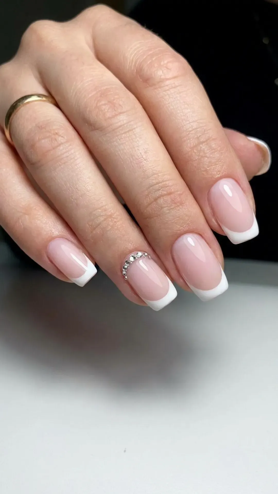 Elegant French manicure with a sheer base, white tips, and a row of sparkling crystals adding glamour to the classic style.