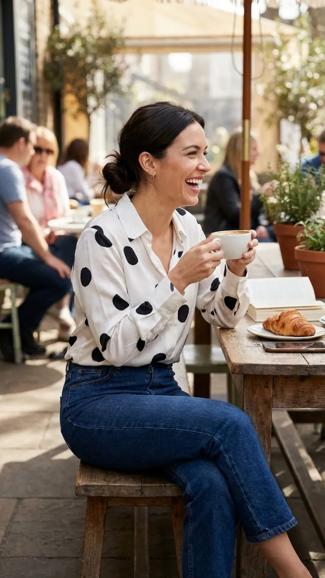 Oversized polka dot silk blouse and dark wash jeans for a stylish outfit