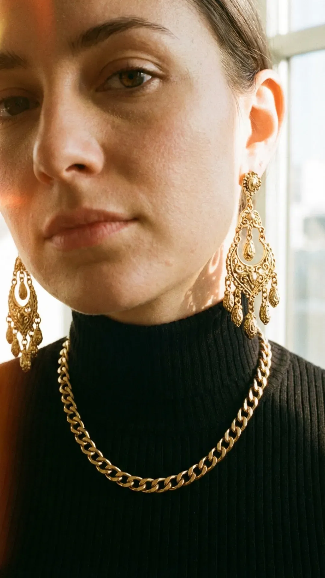 Black turtleneck elevated with heavy chunky gold jewelry for a 2026 trend.