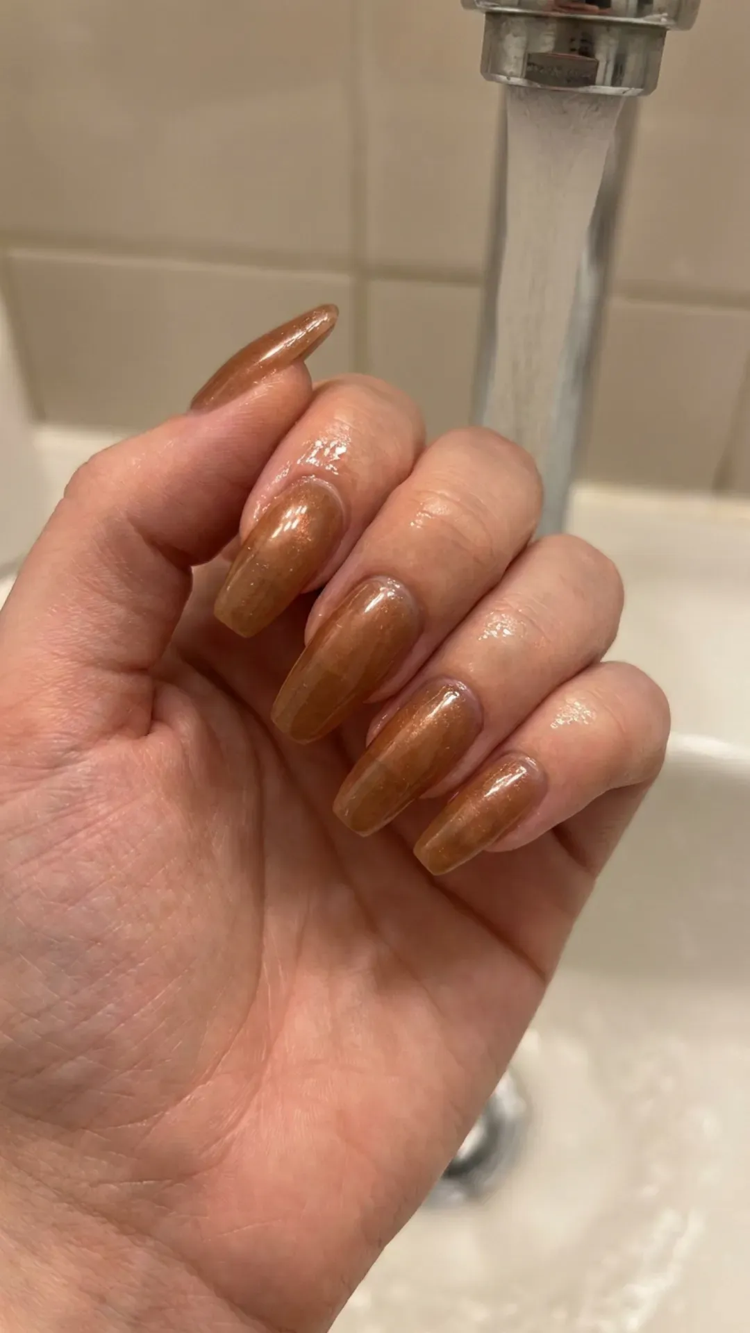 Caramel Bronze Syrup Nails - Glossy bronze shimmer syrup nails under water stream