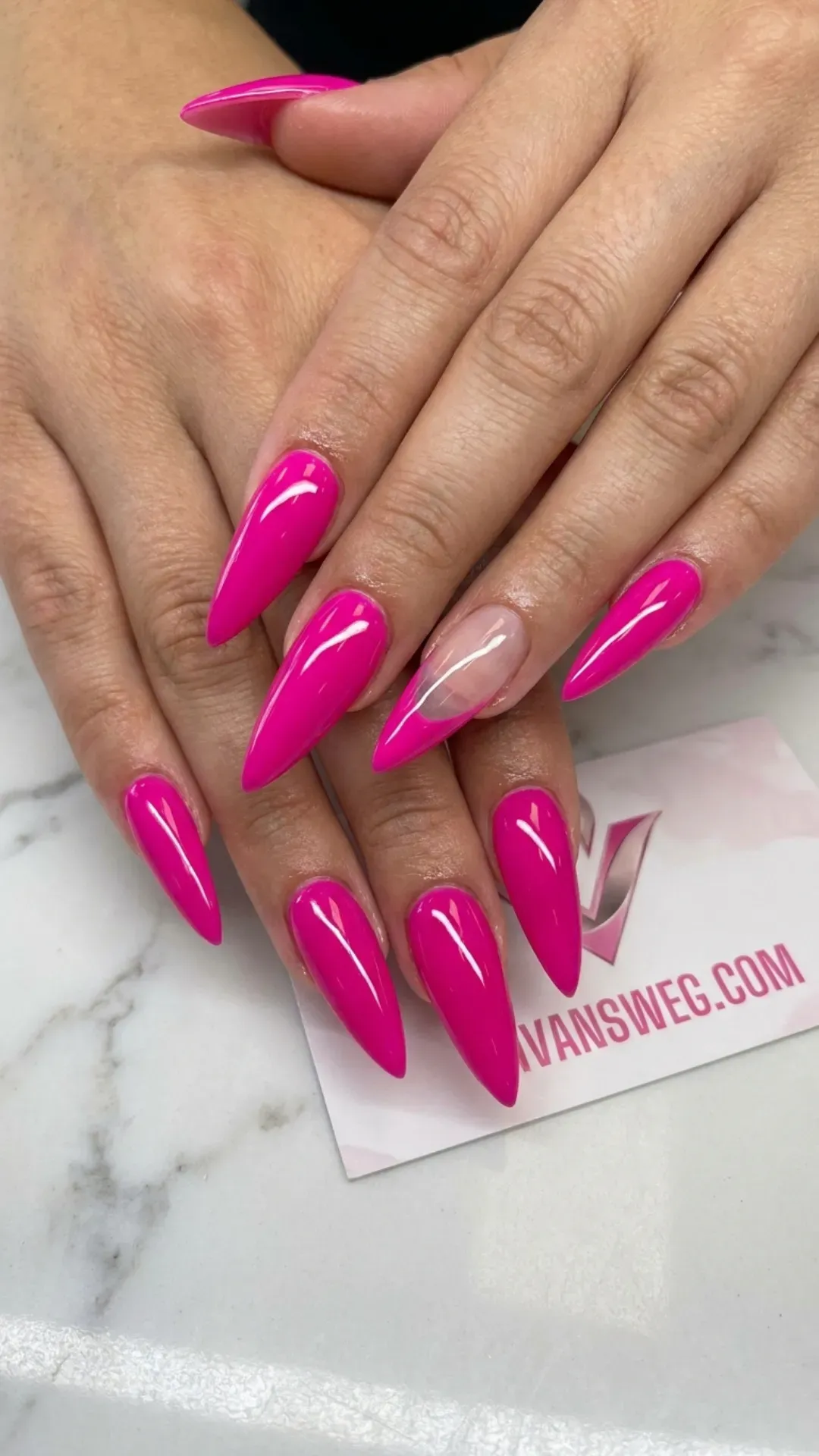 Bright fuchsia pink stiletto nails with an ultra-glossy finish and a clear accent nail with a pink tip by VANSWEG.COM.