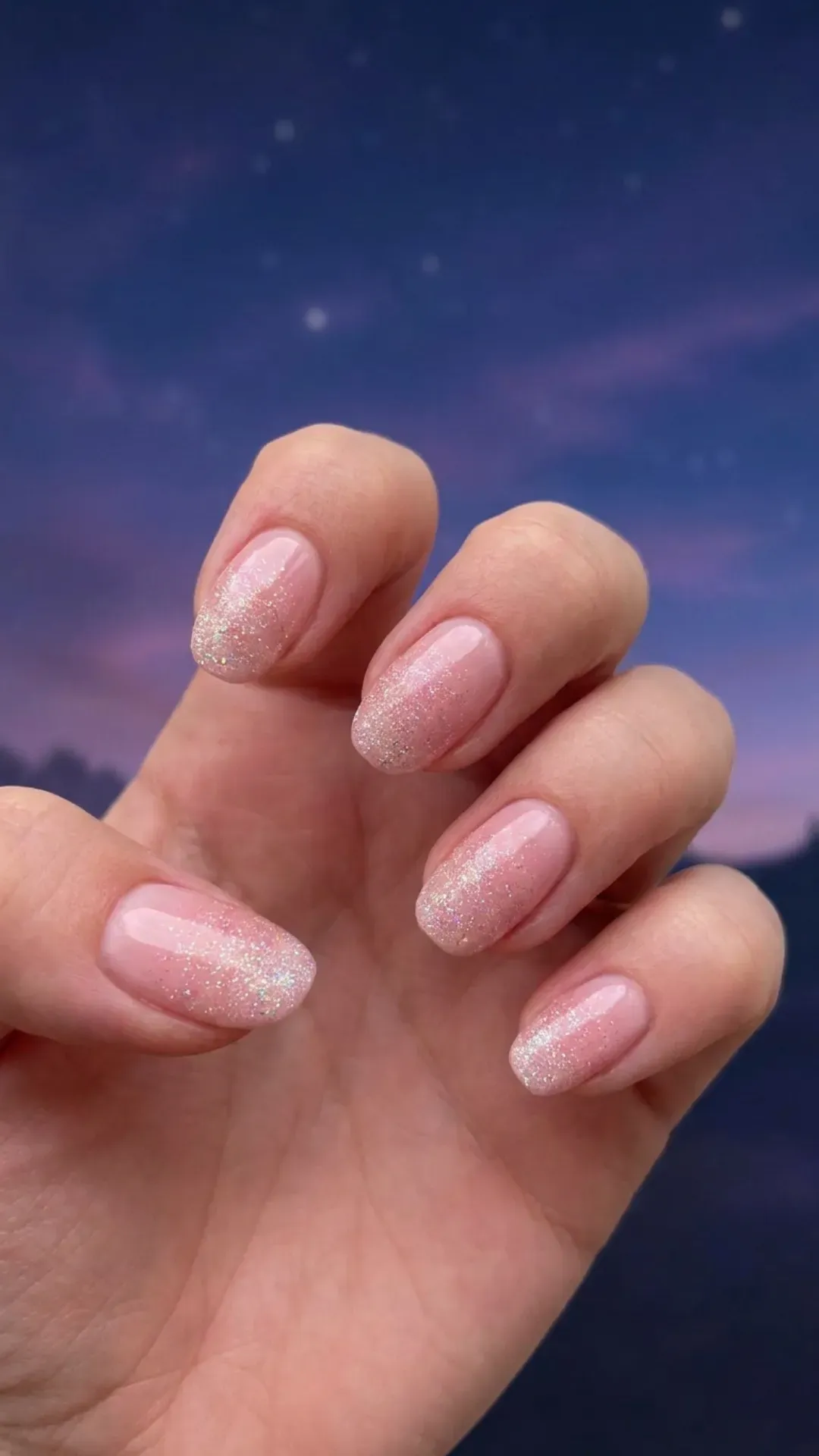 Blush-toned nails with a subtle sparkle, giving the effect of a twilight sky sprinkled with stardust