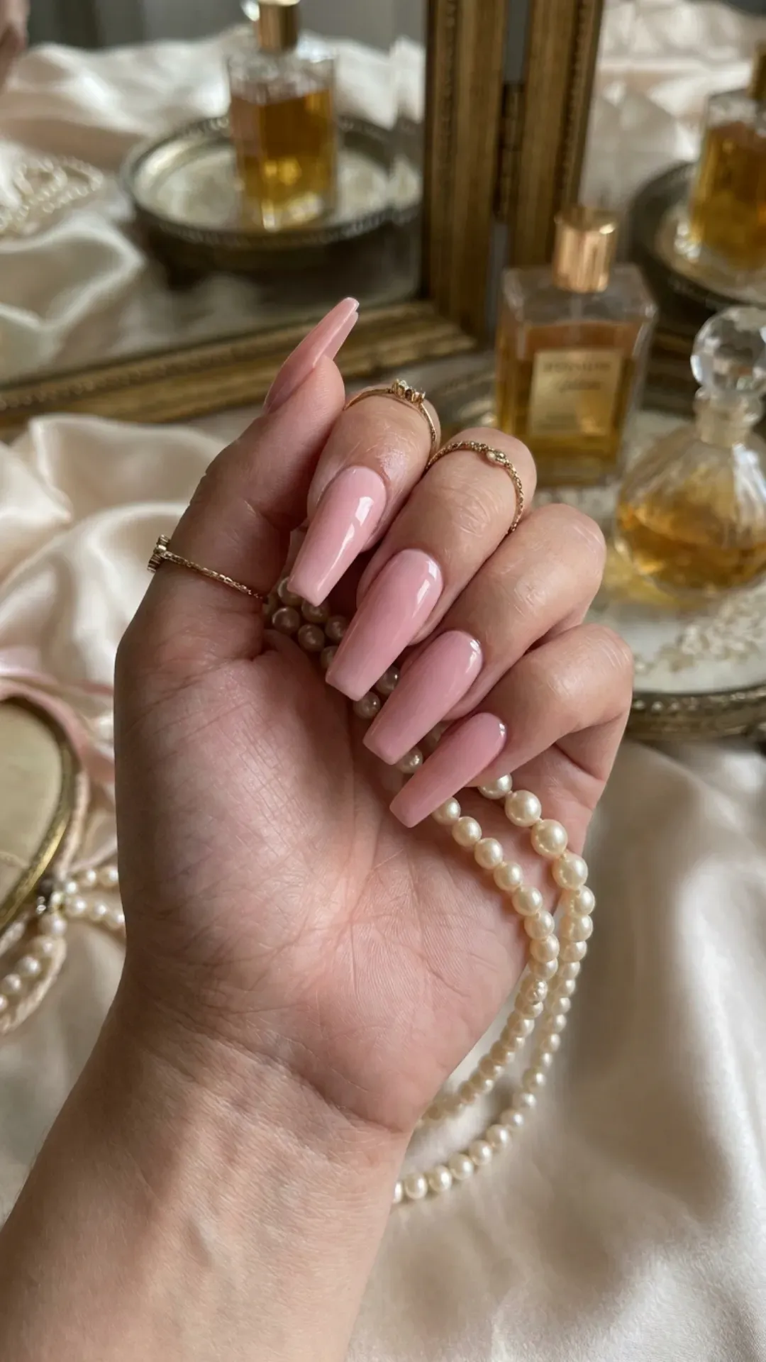 Timeless beauty shines through these classic pink coffin nails with a high-gloss sheen, providing a sleek and polished aesthetic.