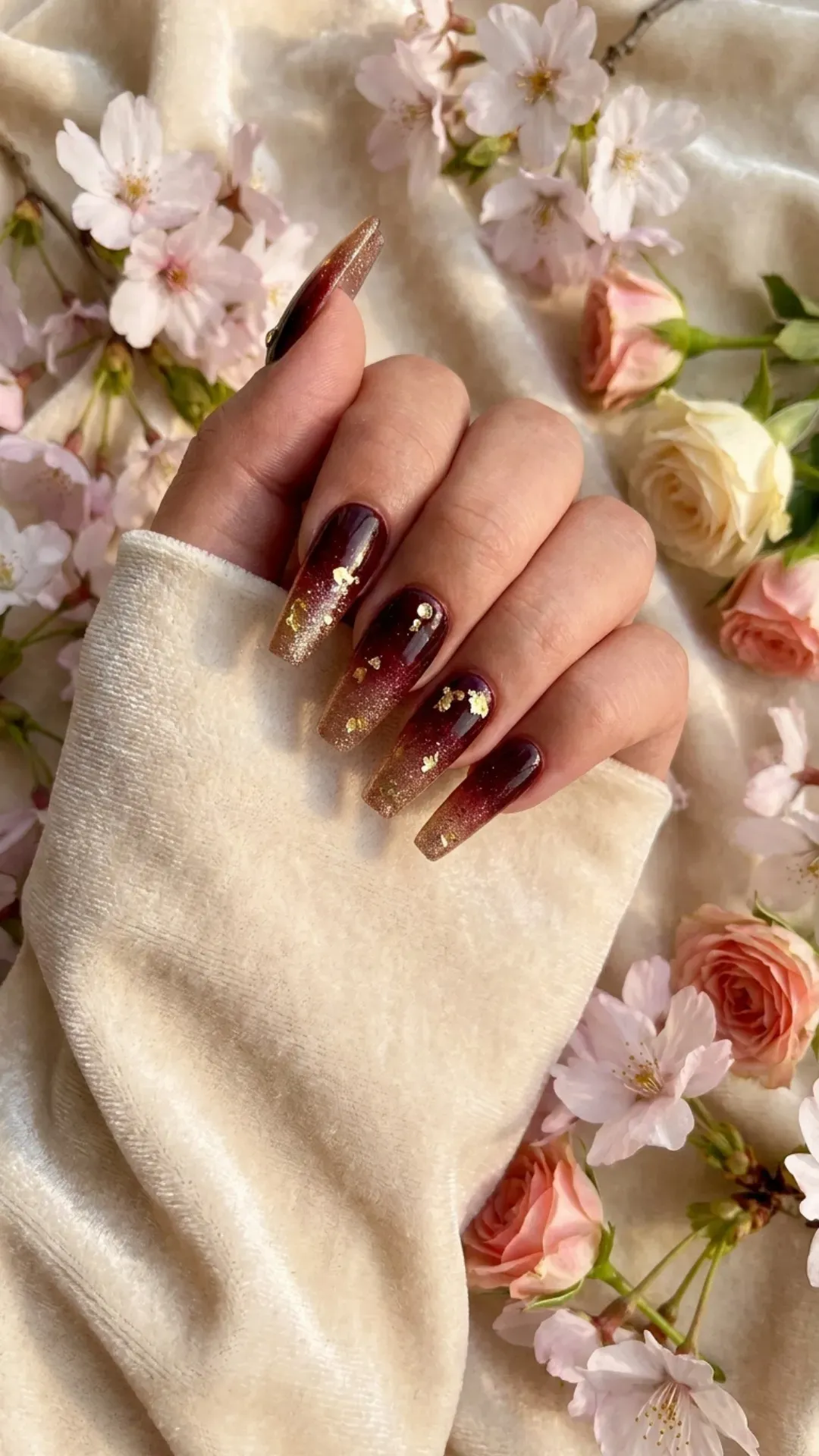 Luxurious coffin nails with a deep red and gold glitter ombre, exuding elegance and glamour for a festive and upscale springtime nail design