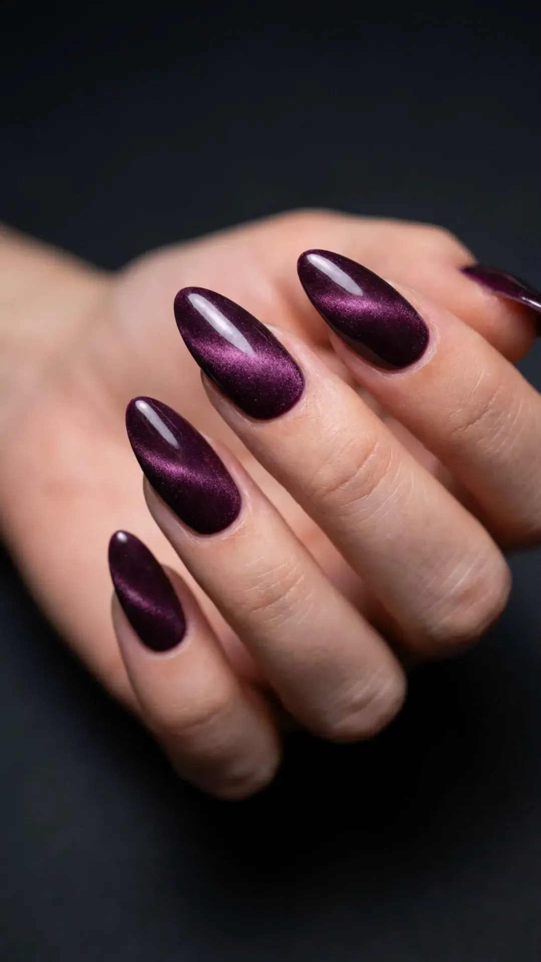 Almond-shaped nails with deep plum velvet cat eye finish, multidimensional magnetic shimmer effect — summer evening nails 2026
