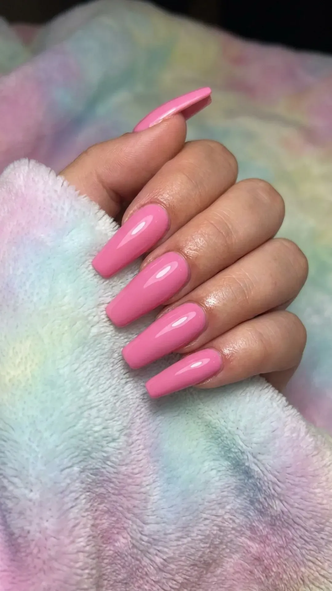 Bold and beautiful coffin nails in a candy pink hue with a high-gloss finish, offering a vibrant pop of color that's both playful and chic.