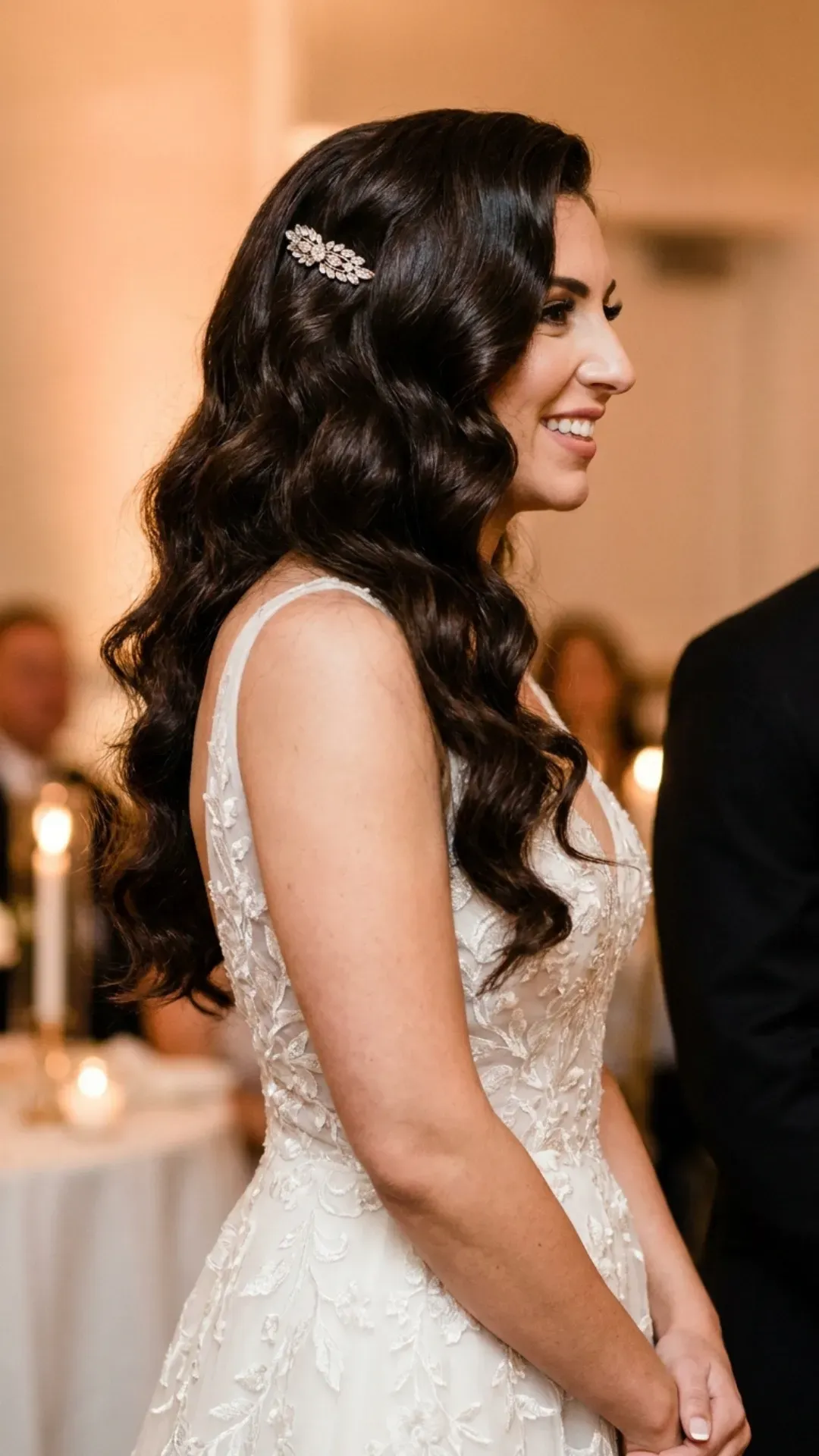 Glamorous long curls with a deep side part, providing both volume and drama, styled for a sophisticated evening wedding to ensure the bride shines.