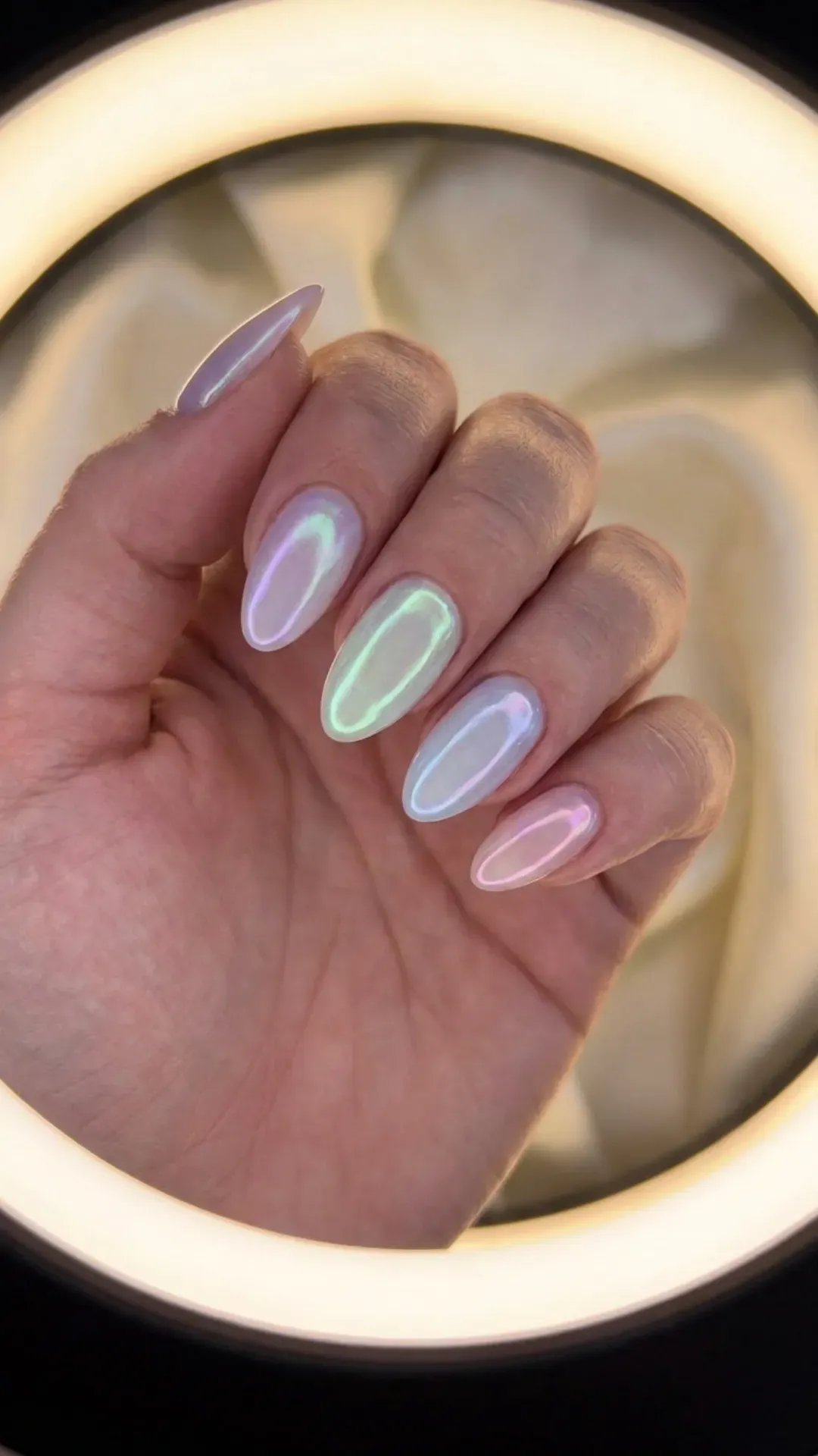 Iridescent Pastel Glow Nails - Close-up of iridescent, glowing pastel nails with a soft shimmer effect
