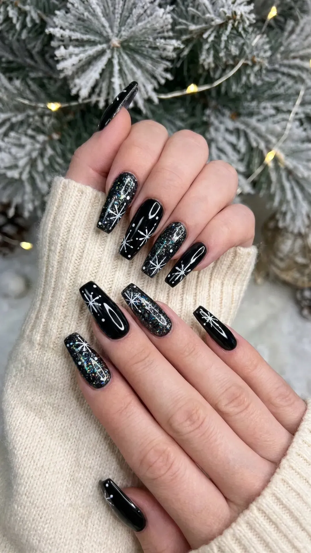 Bold black glitter nails adorned with white snowflake art, offering a glamorous twist on the classic winter wonderland theme.