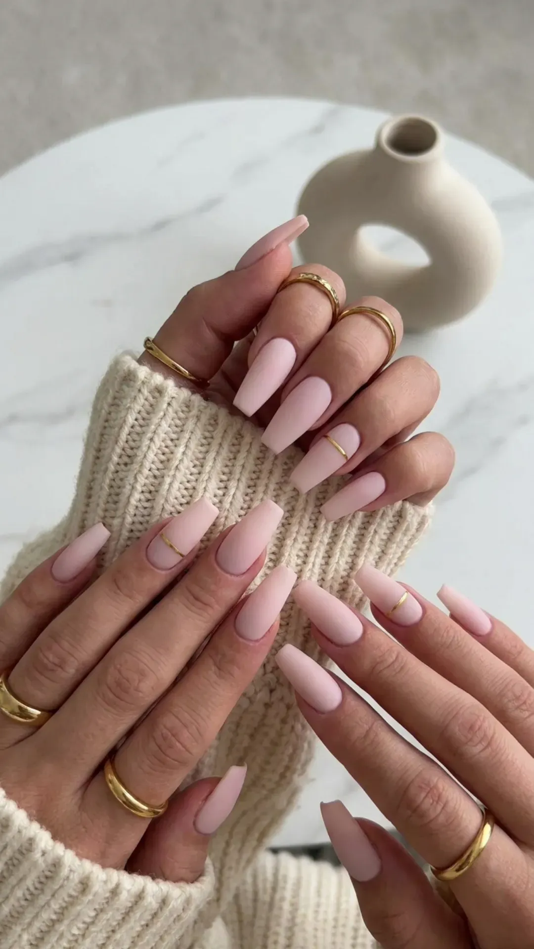Sophisticated and on-trend, these pale pink coffin nails feature a soft matte finish, embodying minimalist chic with a modern twist.