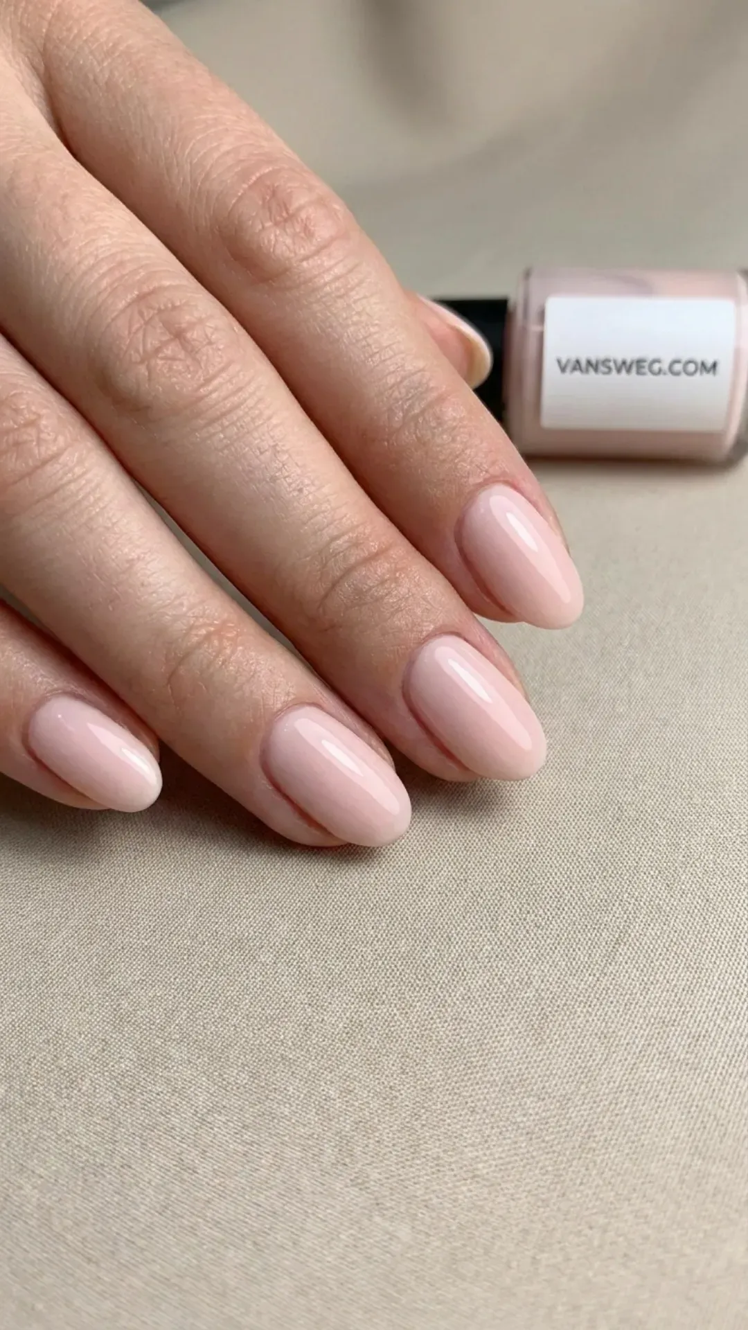 Minimalist short natural manicured nails in a solid, sleek coat of creamy light pink polish by VANSWEG.COM.