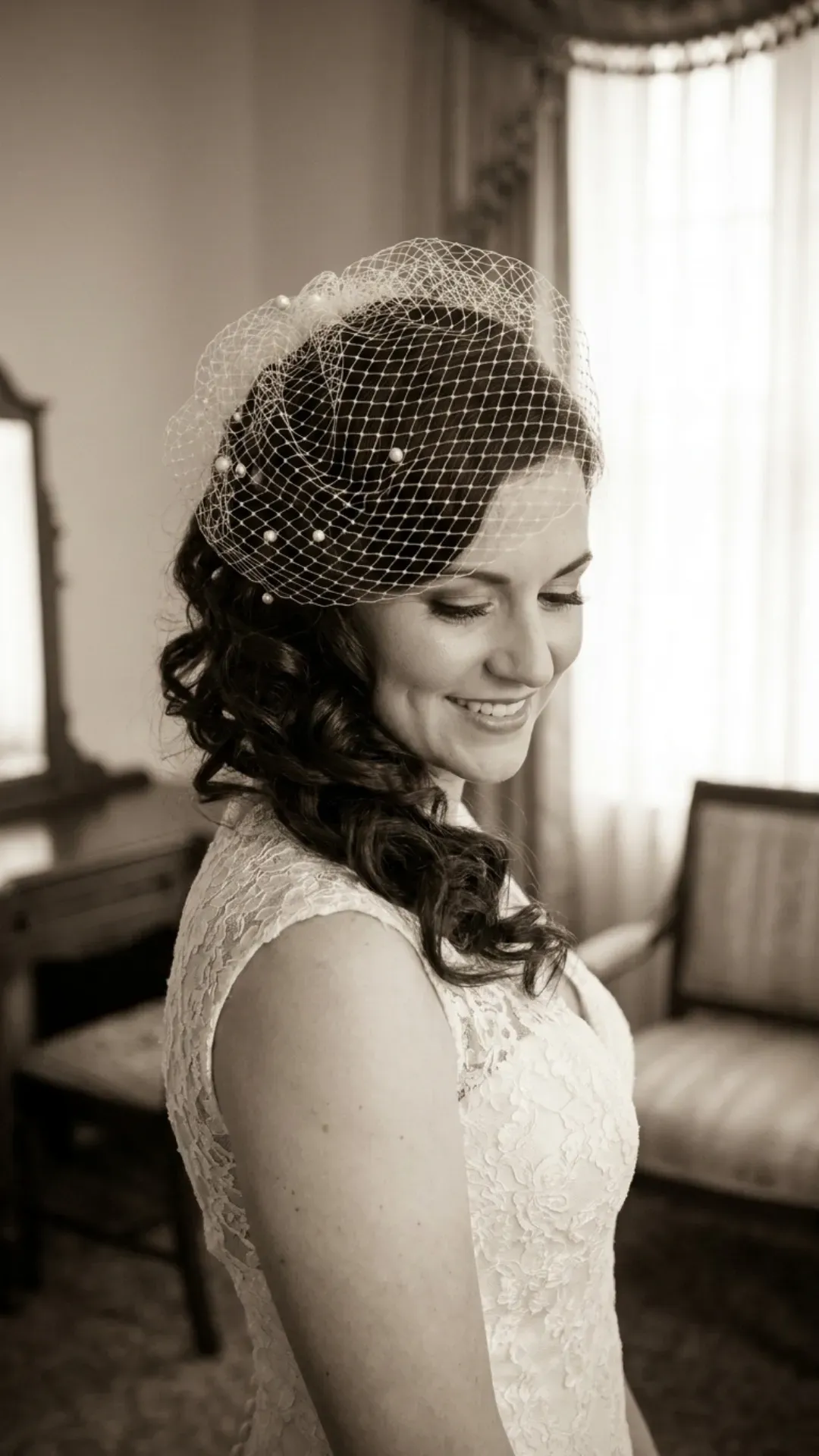 Curly side sweep enhanced with vintage-inspired netting, offering a classic and old-world charm hairstyle for brides who love a touch of vintage elegance.