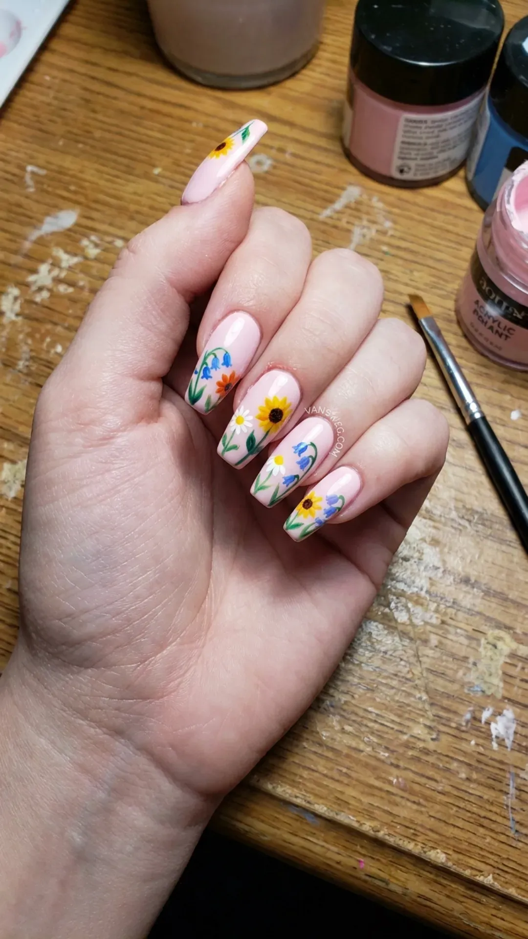Creamy baby pink medium coffin nails decorated with vibrant, colorful hand-painted summer flowers by VANSWEG.COM.