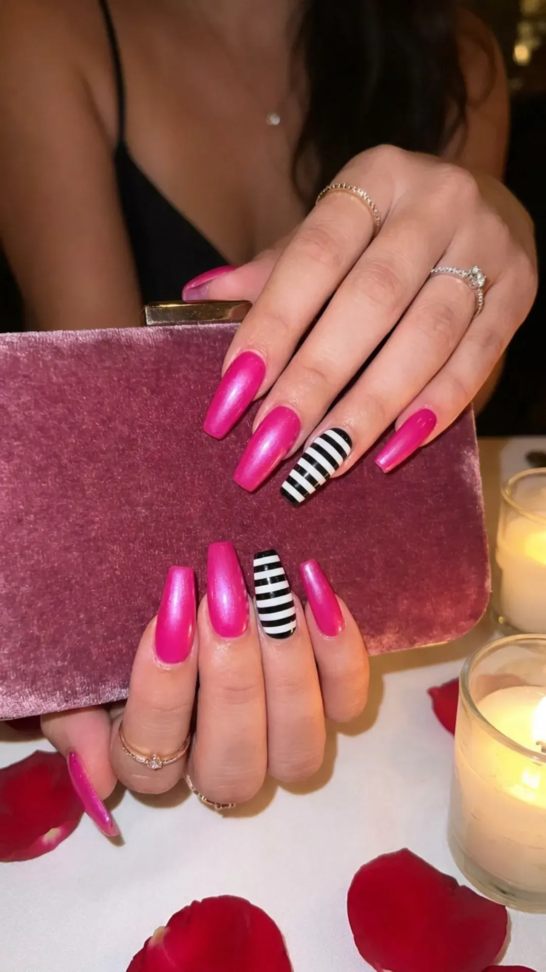 Eye-catching pink coffin nails paired with a bold striped accent nail, creating a romantic and flirtatious look ideal for date nights or special occasions.