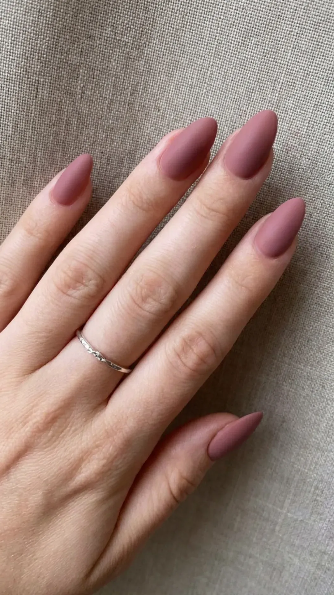 Fashion-forward matte nails in a shade of dusky rose, offering a modern twist on the classic pink manicure