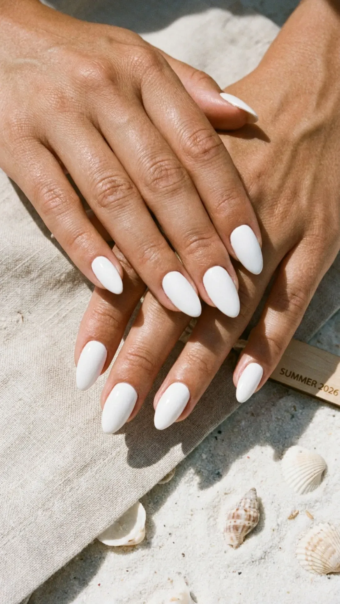 Close-up of bright white nails, highlighting a clean and classic color choice for summer 2026.